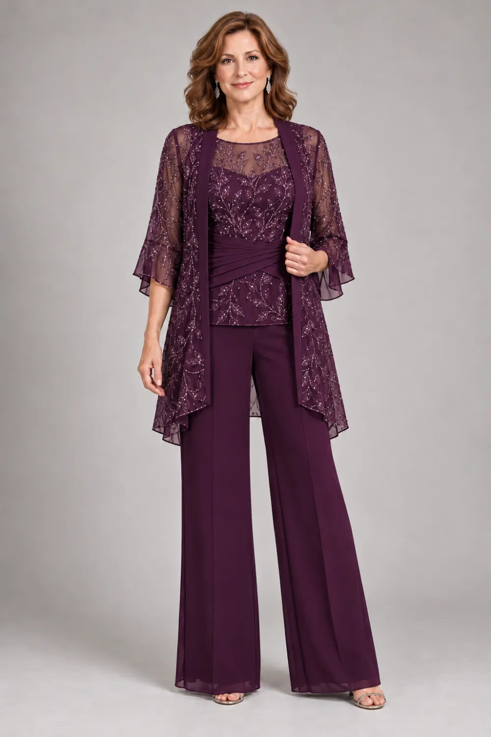 Plum pant suit with floral lace top and diagonal gathered waist, front view.