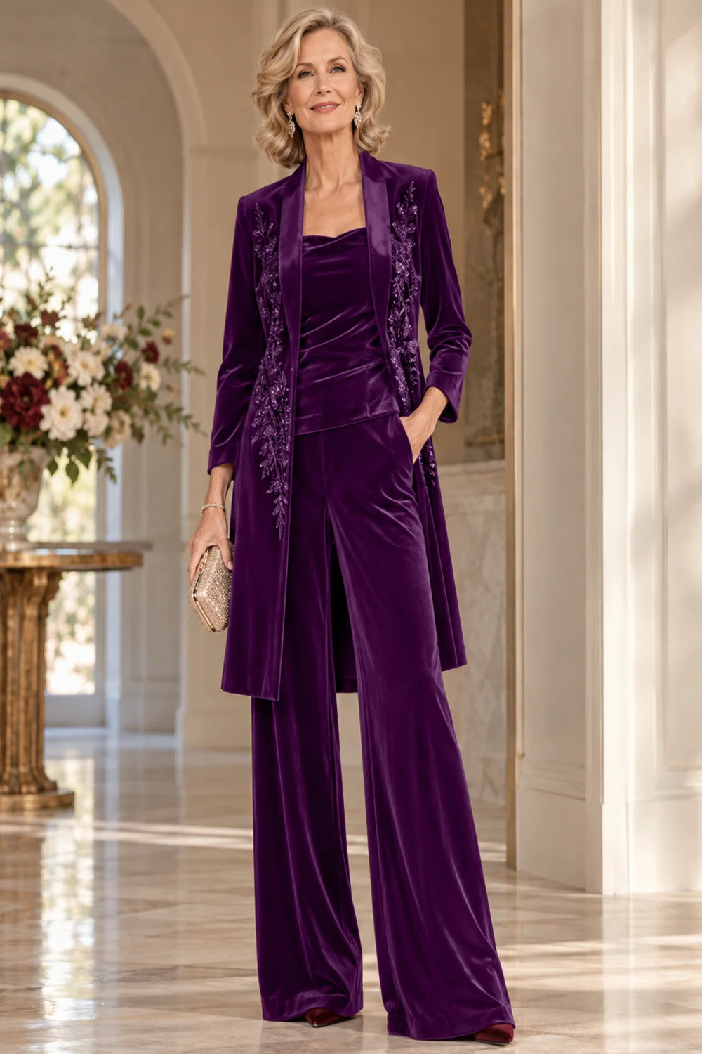 Front view of a purple pant suit with a floral-trimmed long jacket and wide-leg trousers.