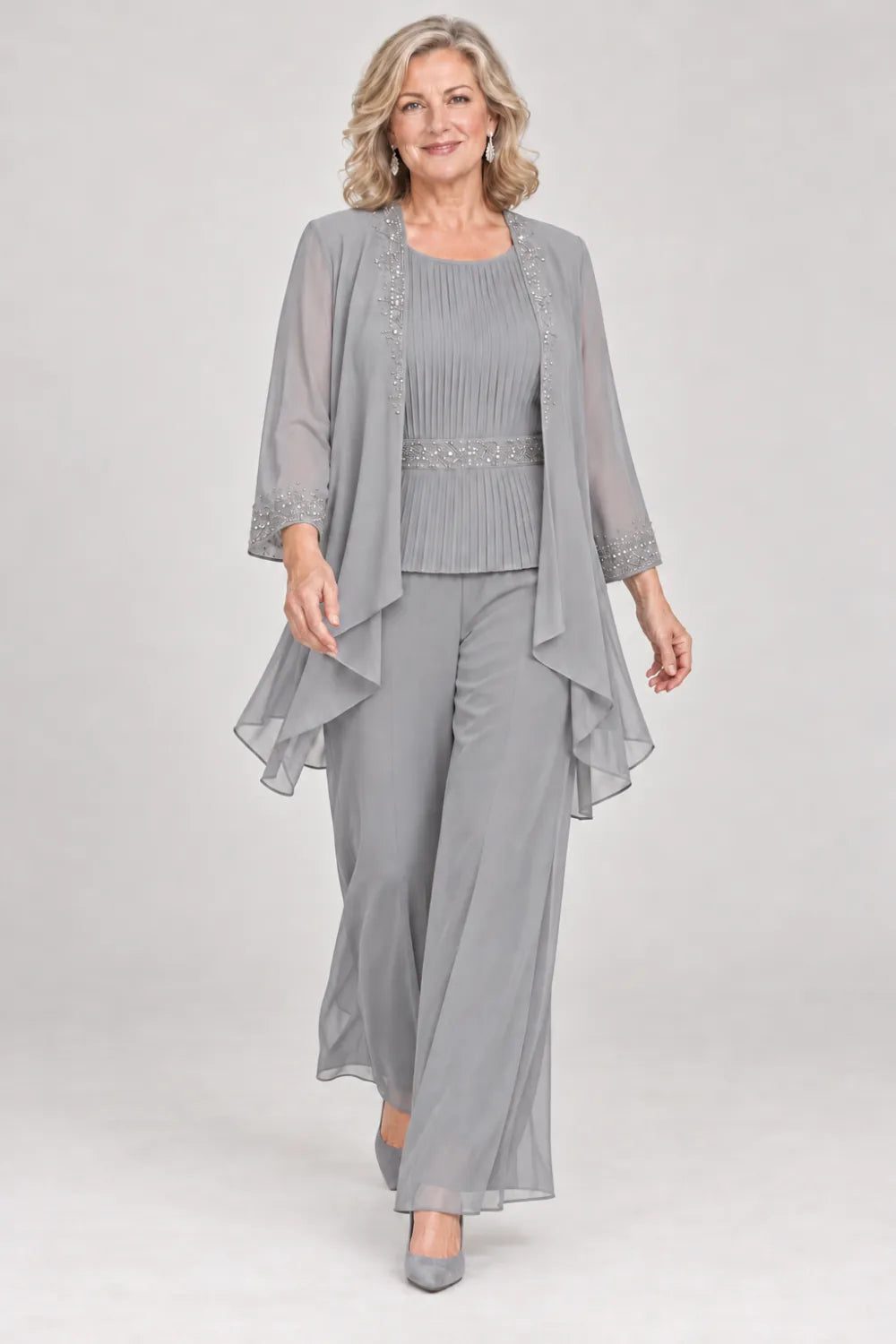 Silver Gray pant suit with pleated top and beaded waist, jacket edges and cuffs, front view.