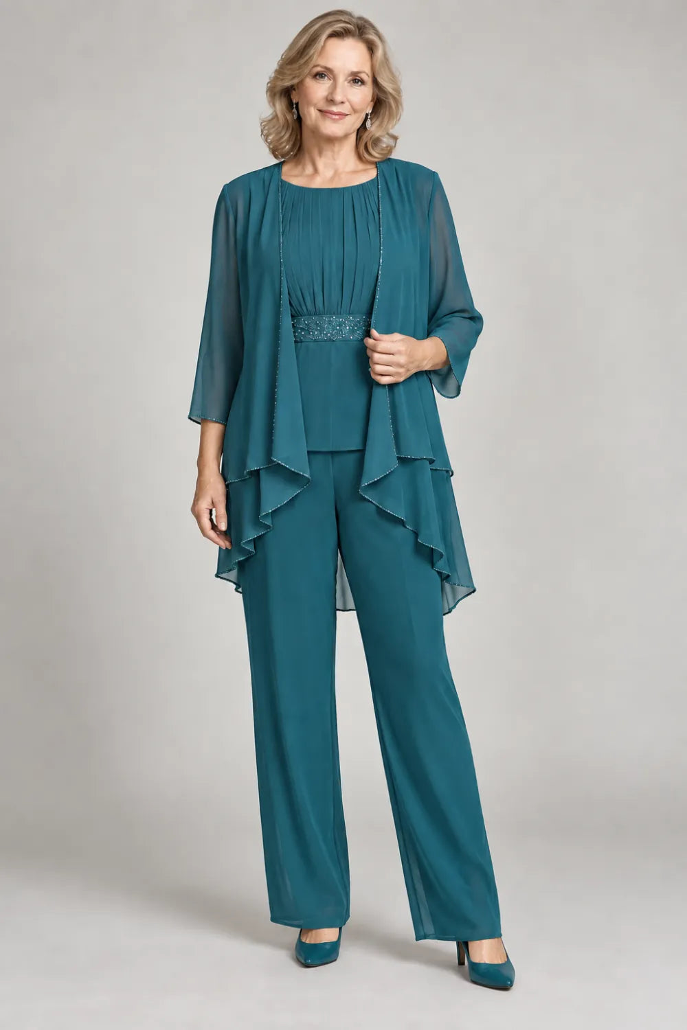 Teal pant suit with gathered top and decorated horizontal waist band, front view.
