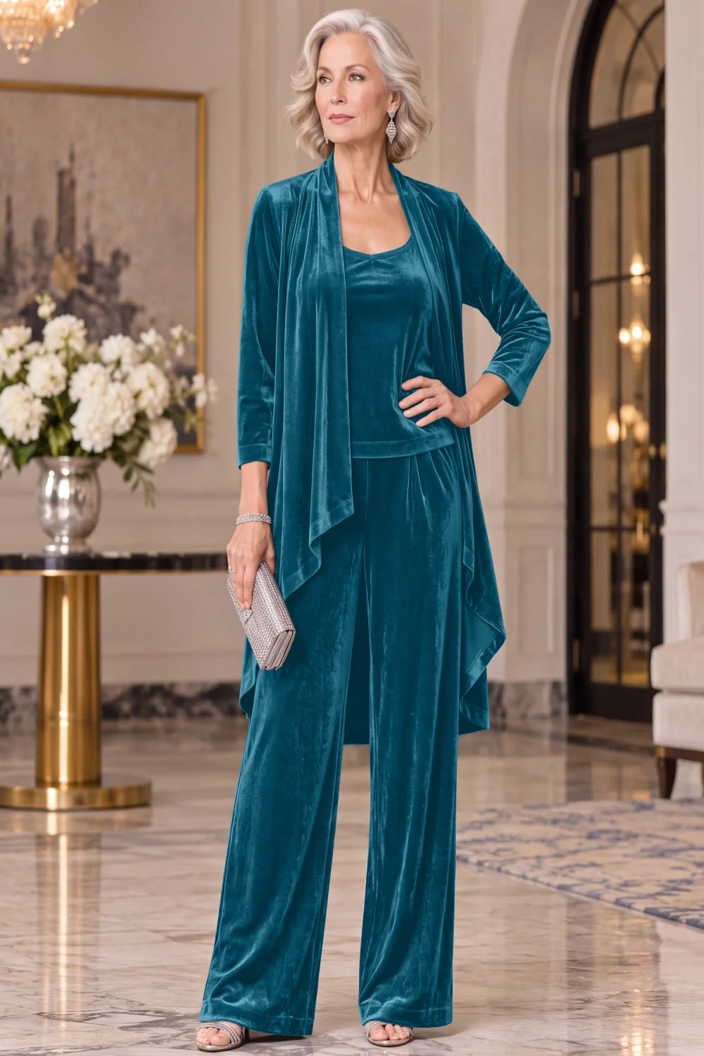Front view of a teal pant suit with a long waterfall jacket and wide-leg trousers.