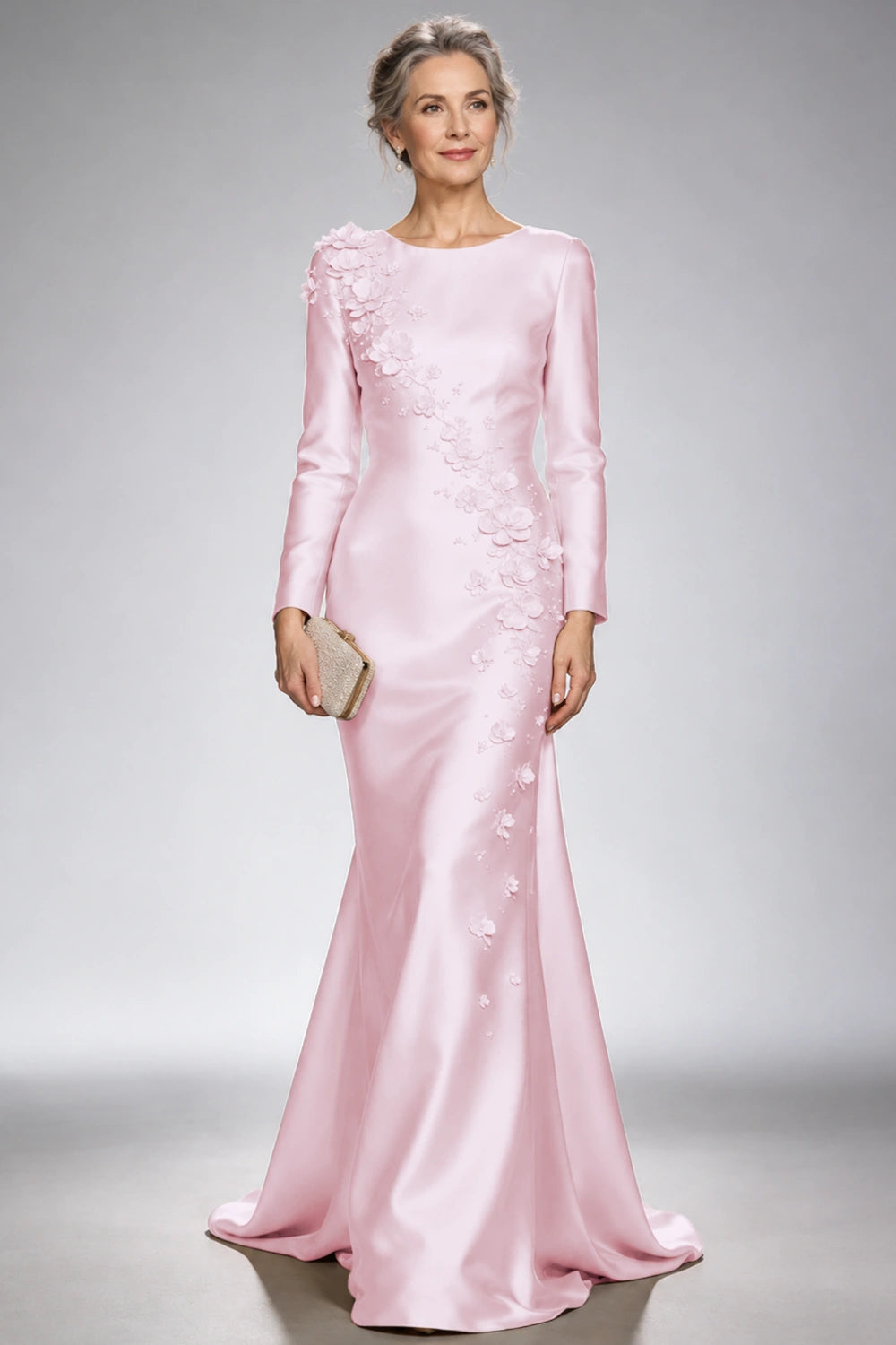 Front view of the blush pink satin mermaid dress with long sleeves and diagonal floral appliques across the bodice and skirt.