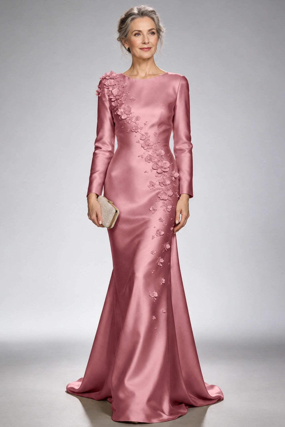 Front view of the dusty rose satin mermaid dress with long sleeves and diagonal floral appliques across the bodice and skirt.