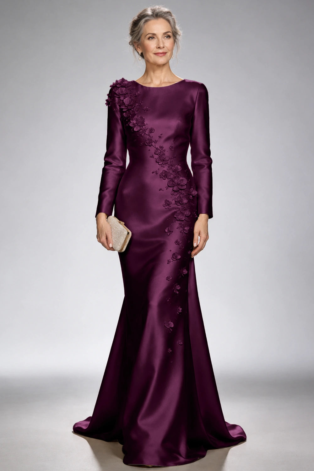 Front view of the purple satin mermaid dress with long sleeves and diagonal floral appliques across the bodice and skirt.
