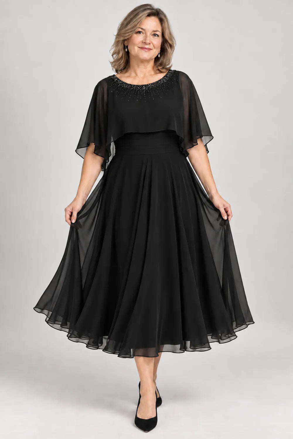 Black dress with narrow beaded neckline and defined waist, front view.