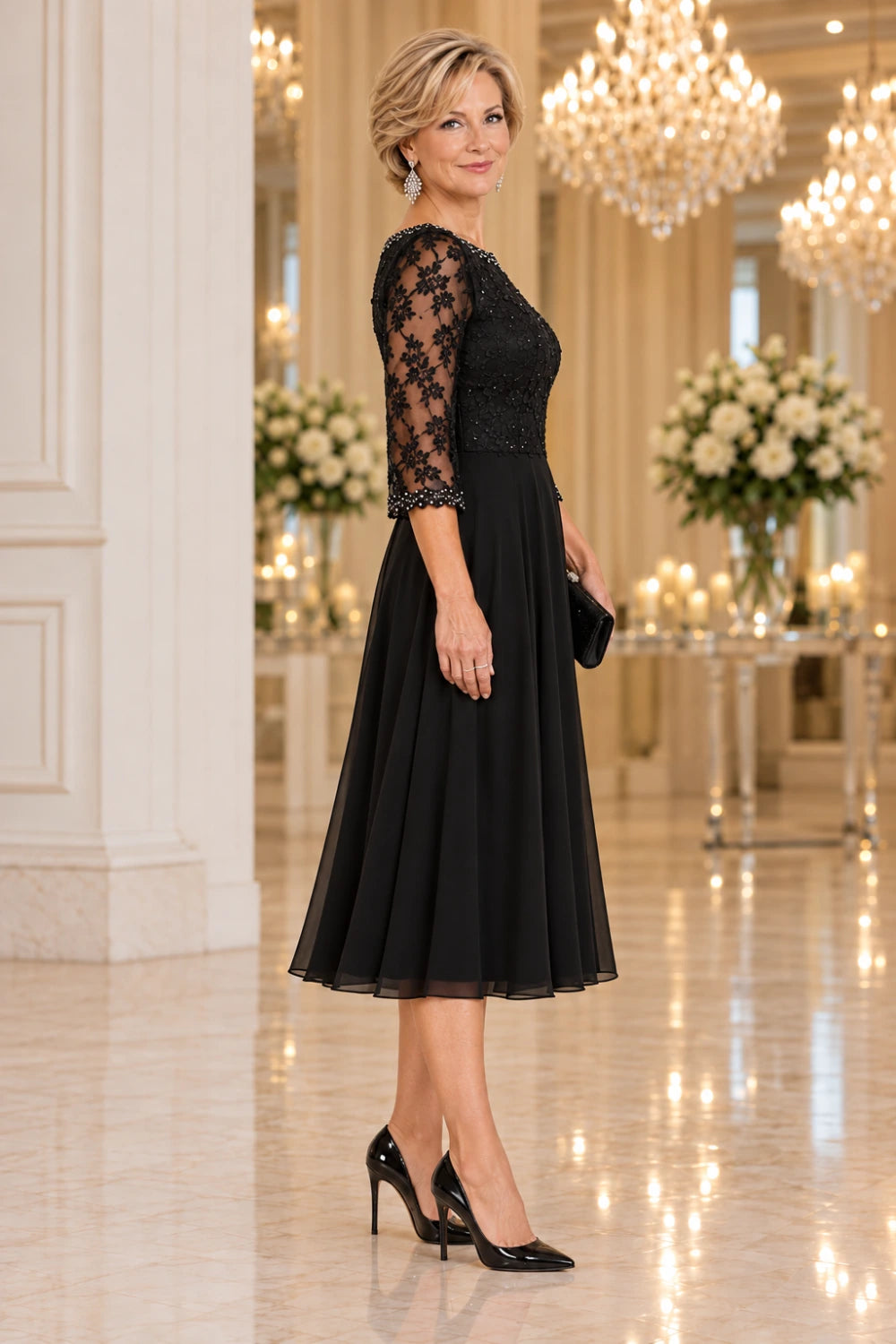 Side view of the black midi dress showing the fitted lace bodice, three-quarter sleeve and flared skirt.