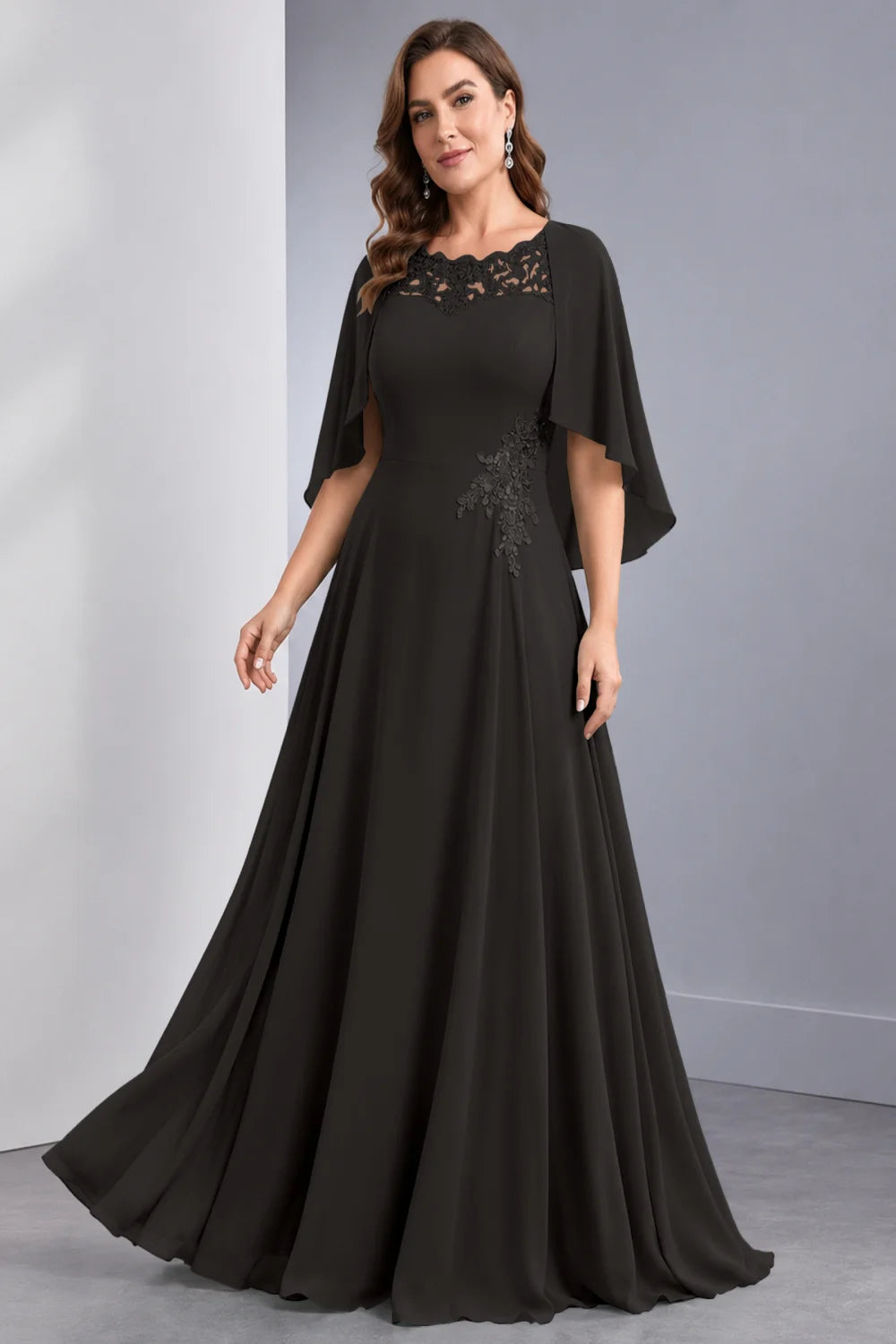 Front view of a black dress with draped sleeve panels and a lace neckline.