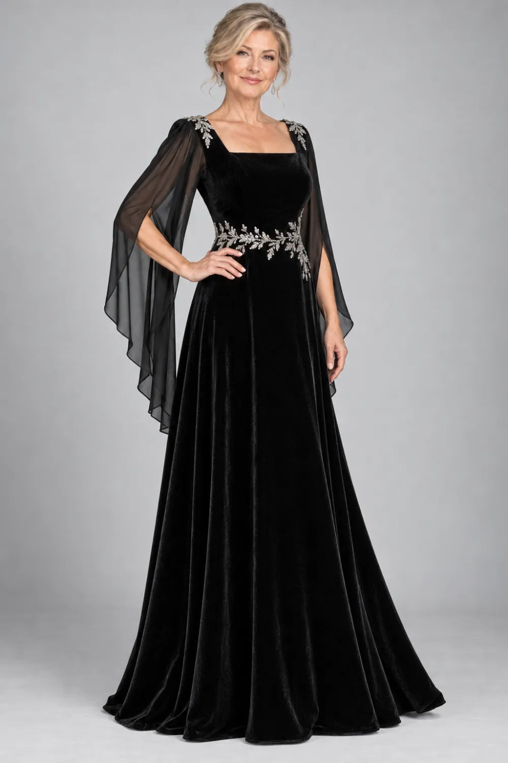 Black dress with silver-tone leafy waist and shoulder accents, front view.