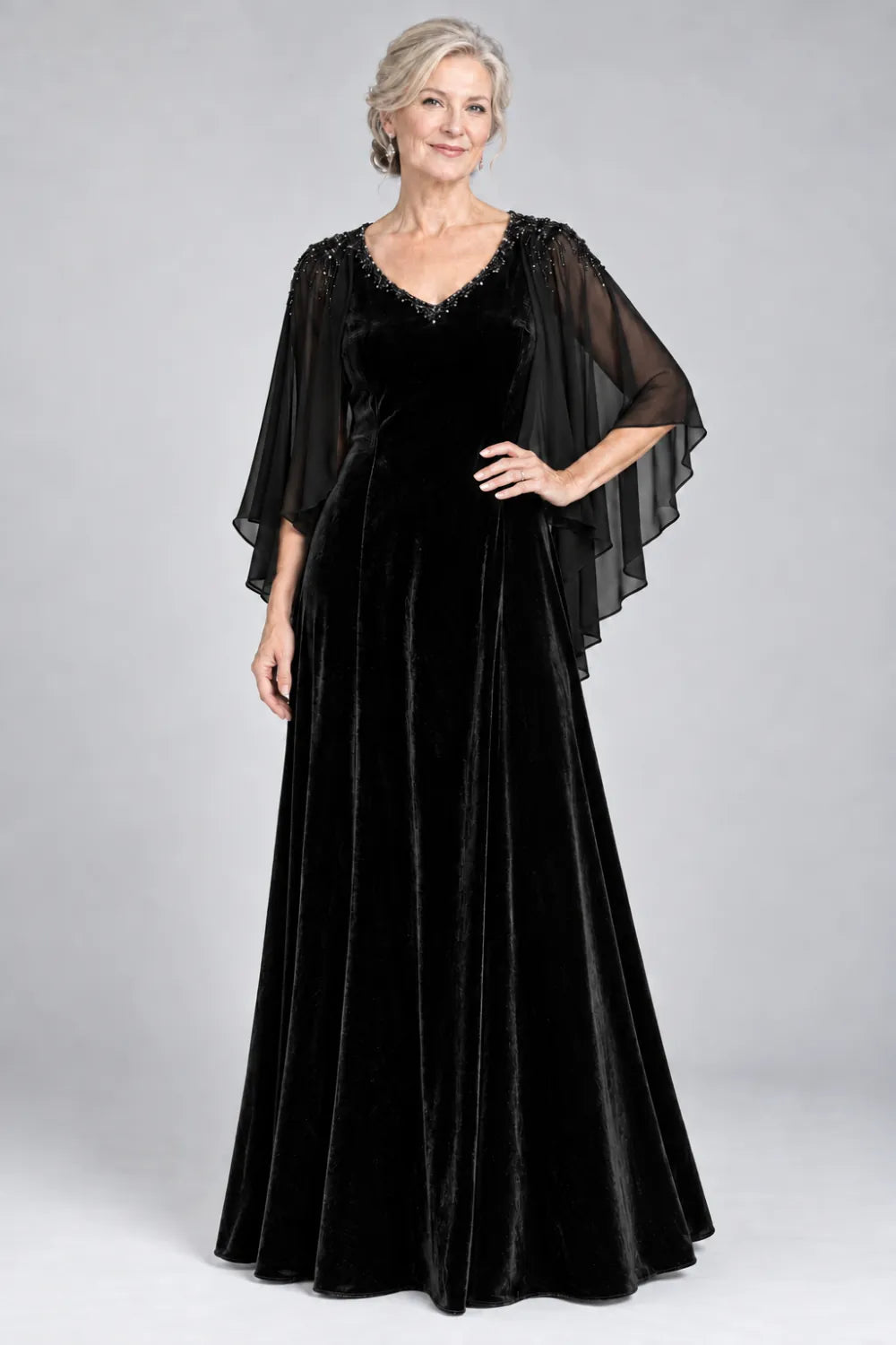 Black dress with beaded v-neck and layered cascading cape, front view.