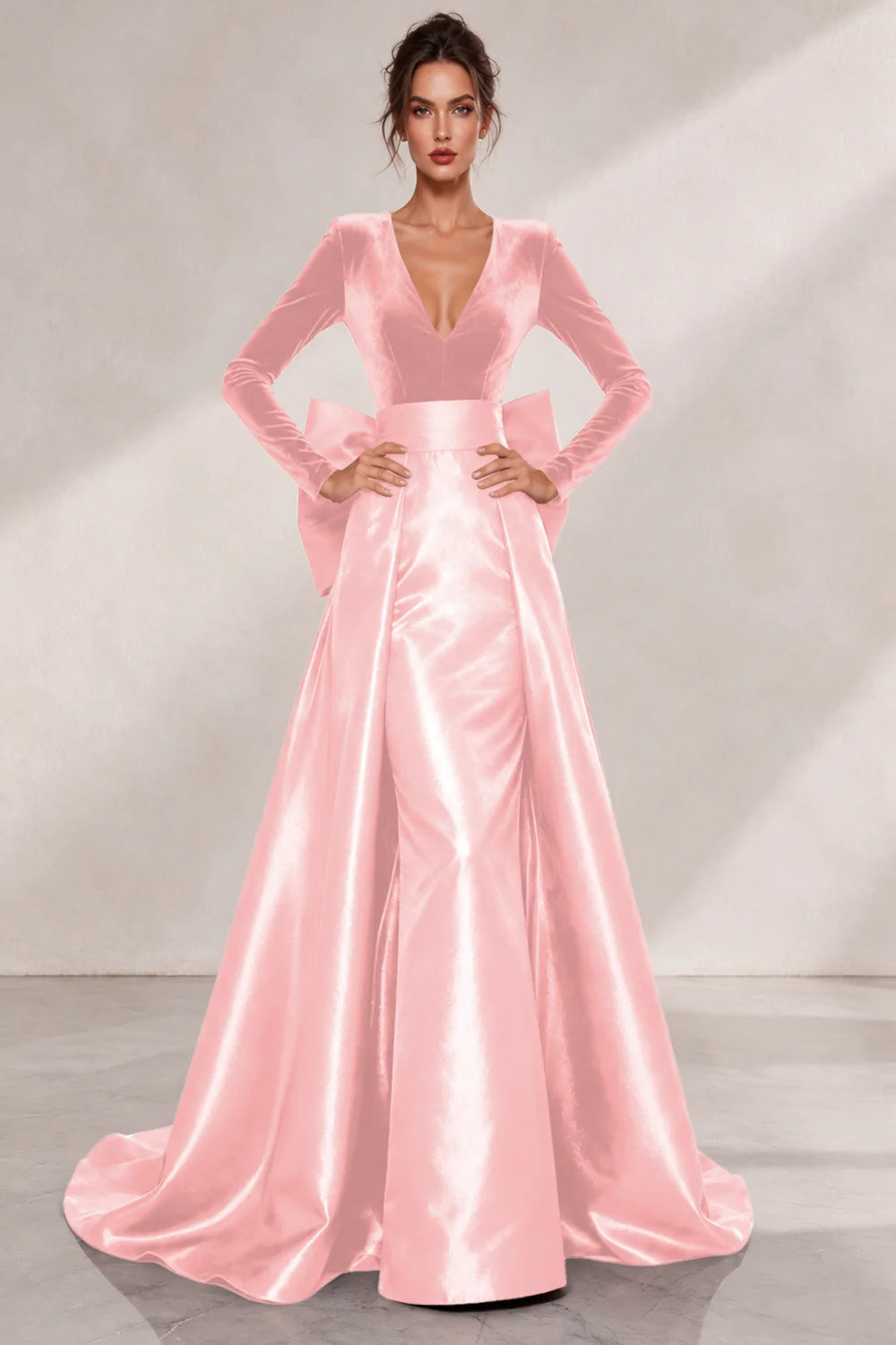 Front view of a blush pink dress with a V neckline and a lustrous full skirt.