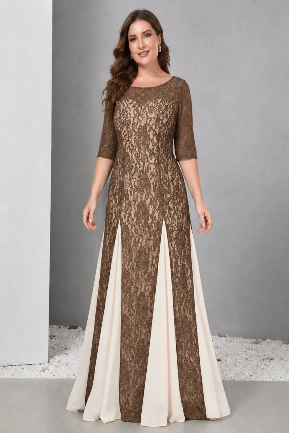 Front view of a brown dress with lace and contrasting pale skirt panels.