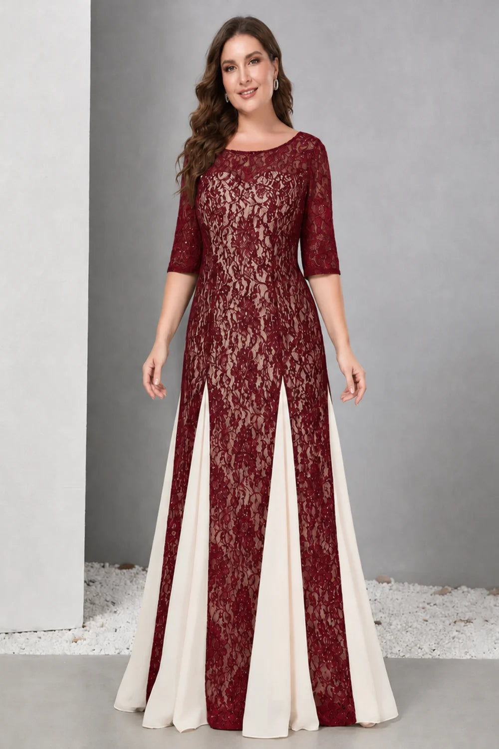 Front view of a burgundy dress with lace and contrasting pale skirt panels.