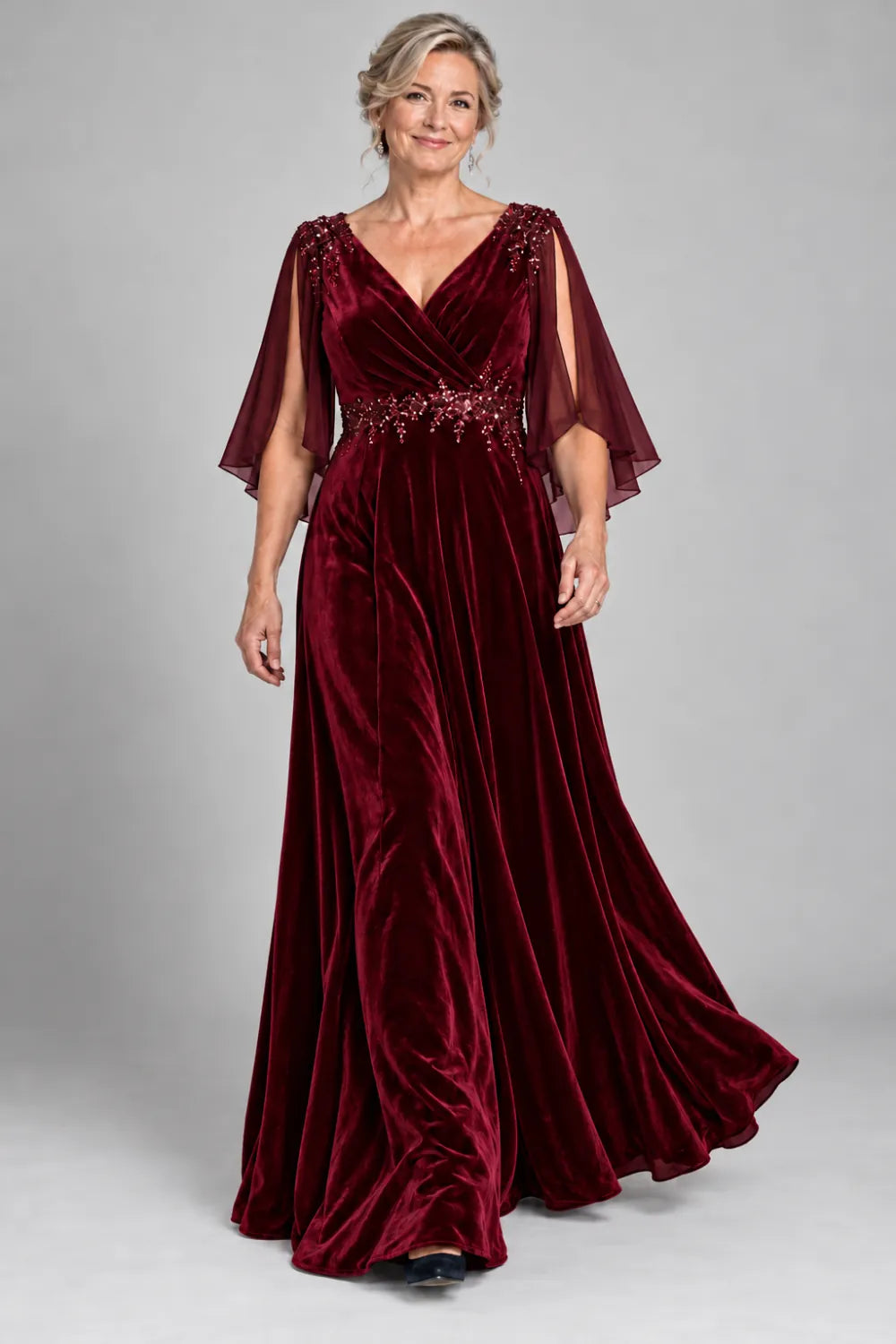 Burgundy dress with crossover bodice and decorated waist, front view.