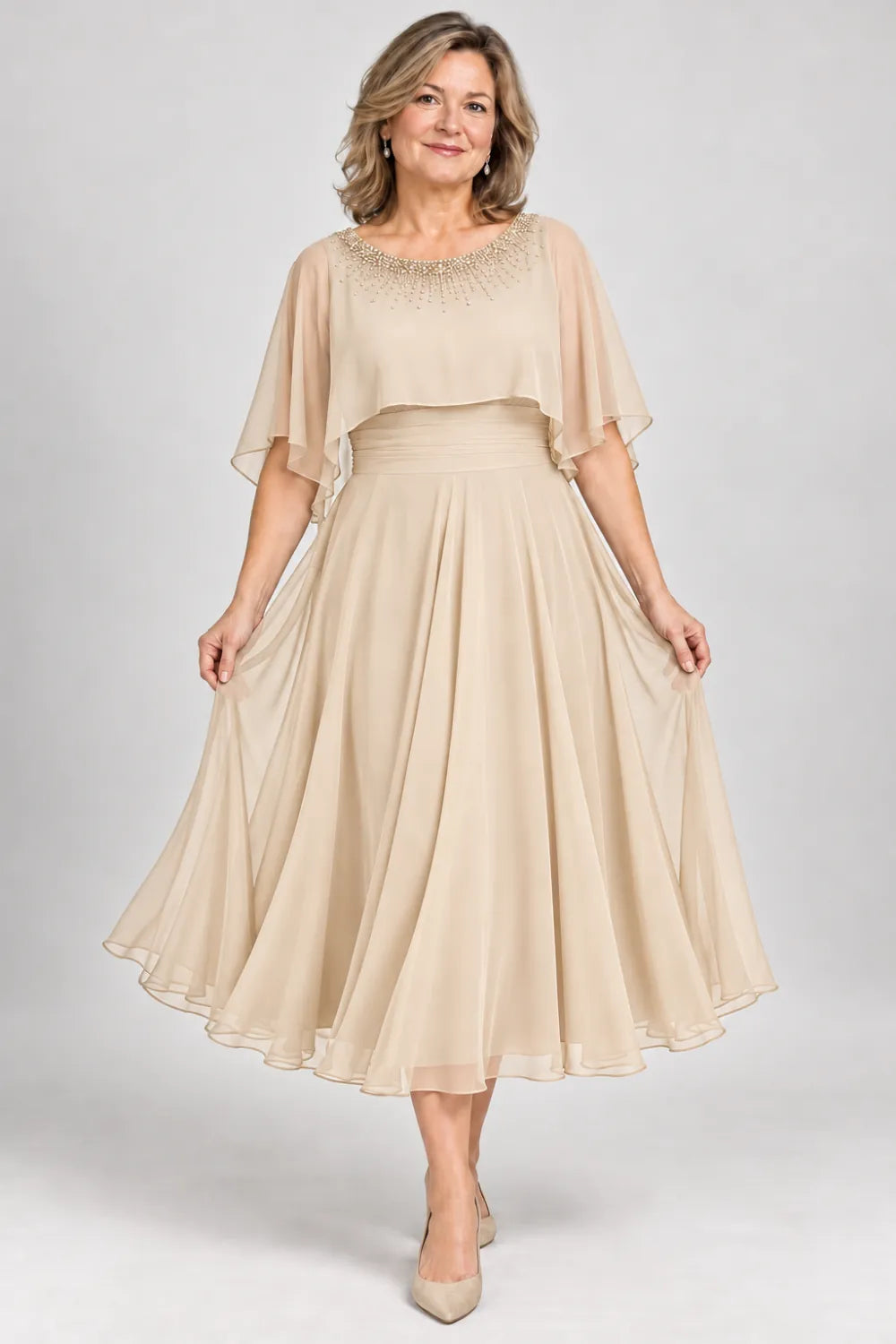 Champagne dress with narrow beaded neckline and defined waist, front view.