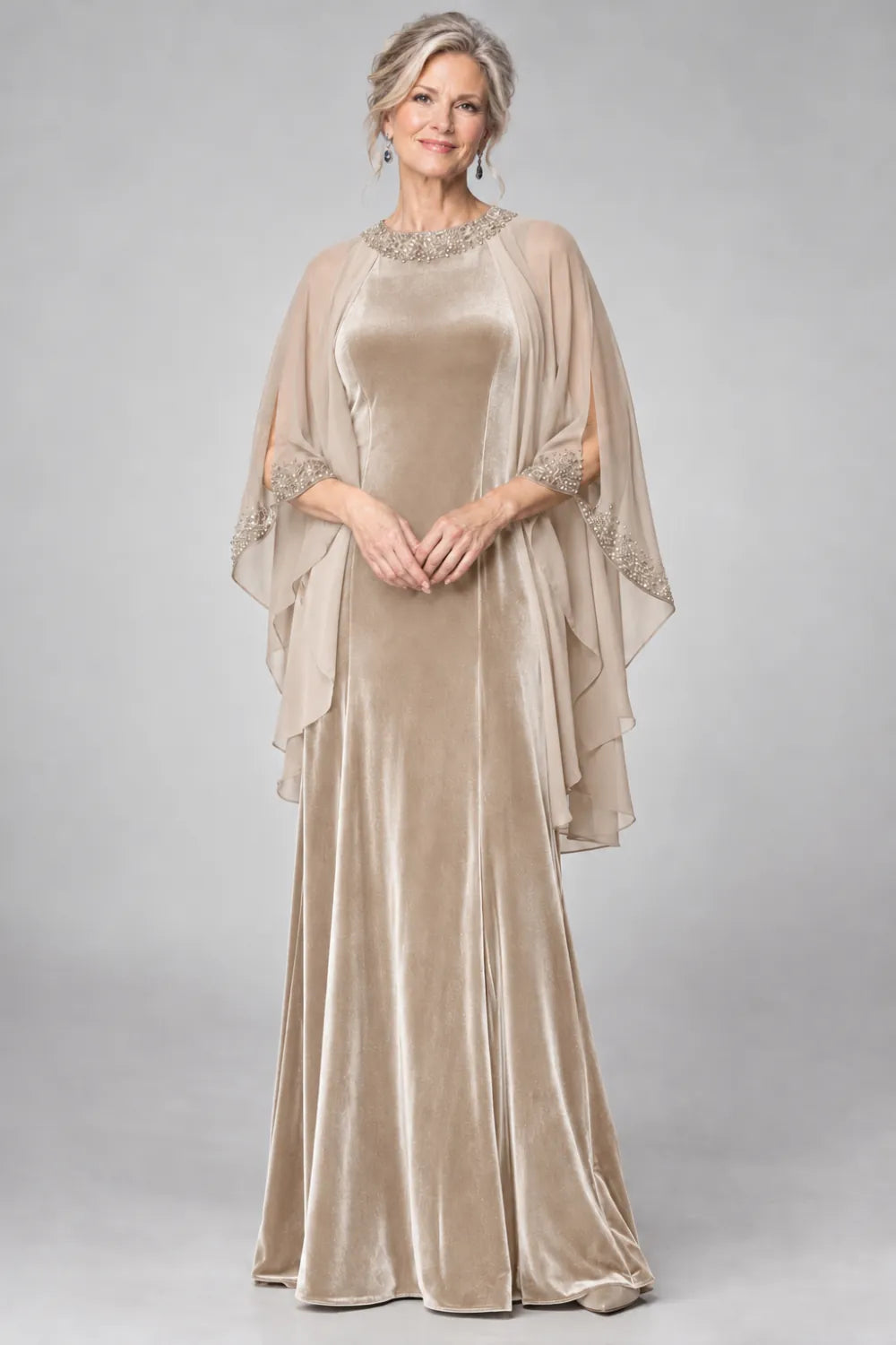 Champagne dress with beaded round neckline and cascading sheer cape, front view.