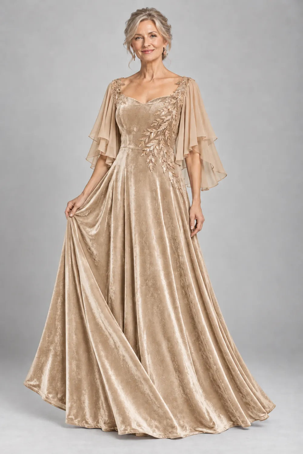 Champagne dress with diagonal gold-tone leaf embroidery, front view.