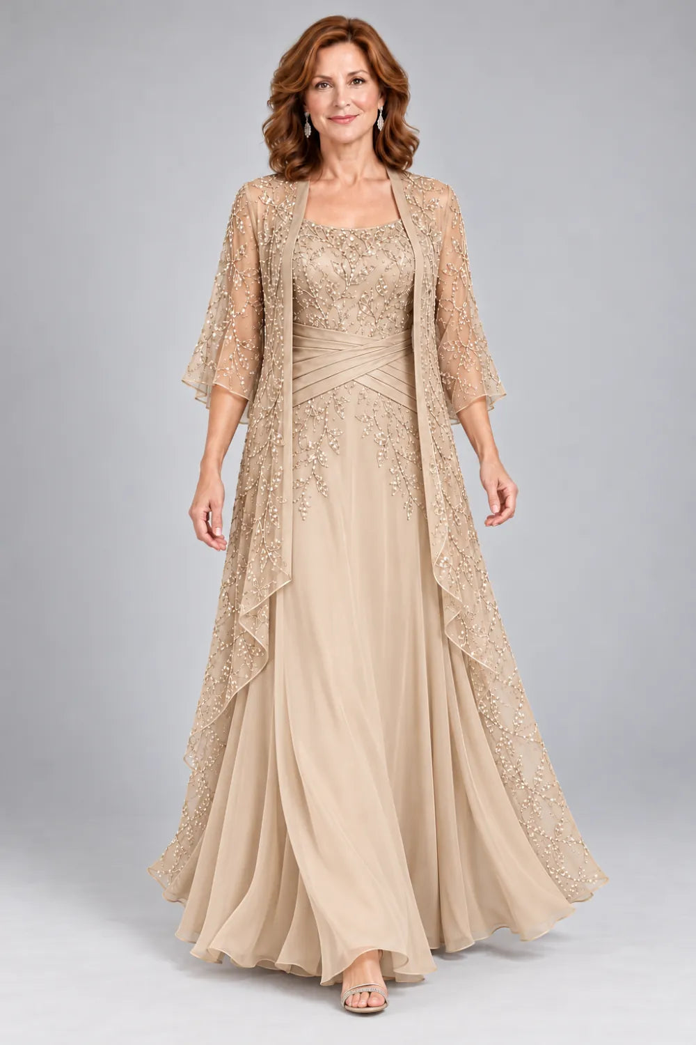 Champagne dress with lace bodice, diagonal waist gathers and cascading skirt panel, front view.