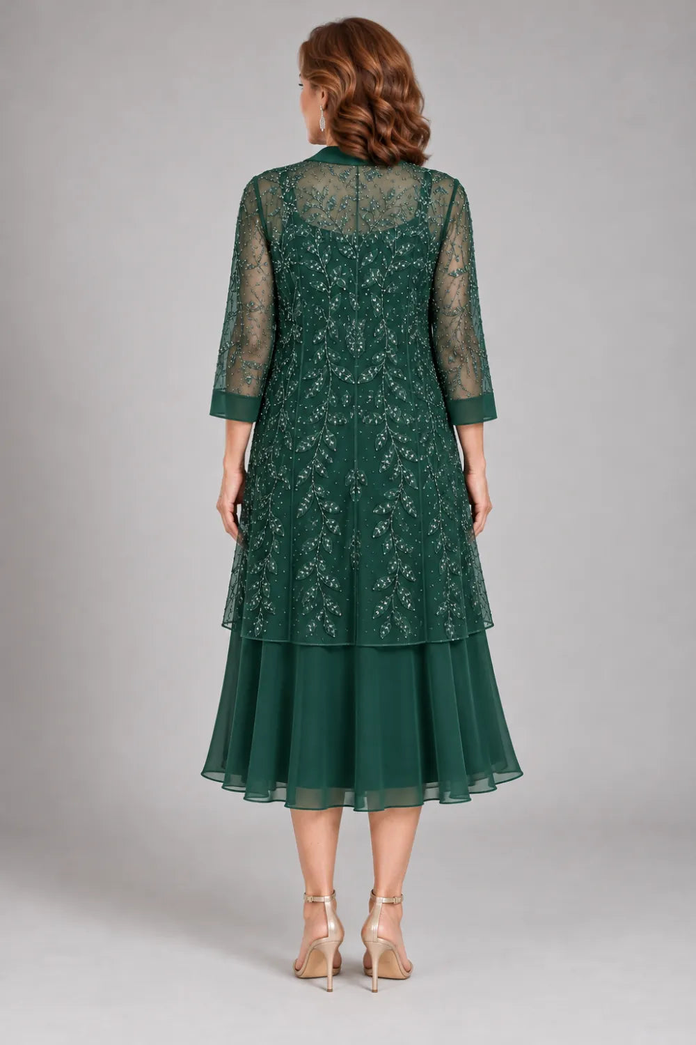 Back view of a emerald green tea-length a-line dress with longline open lace jacket.