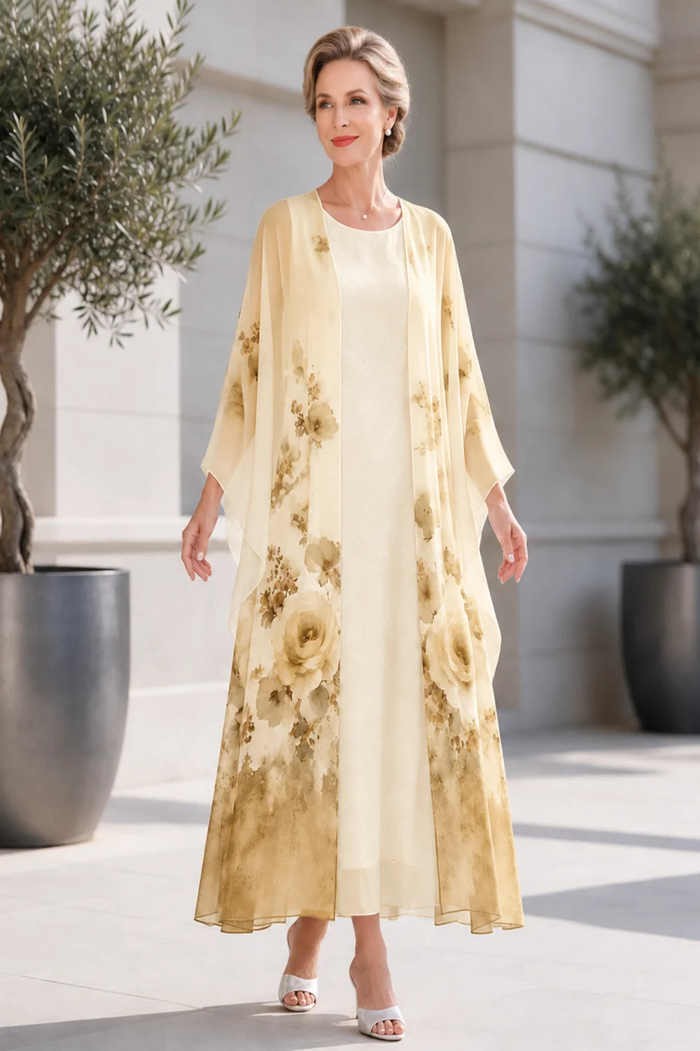 Front view of a gold dress with a long floral outer layer.
