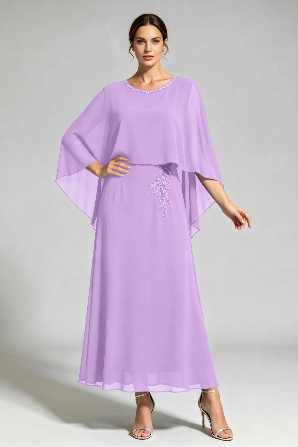 Front view of the lavender cape dress with a beaded round neckline and tonal floral applique.