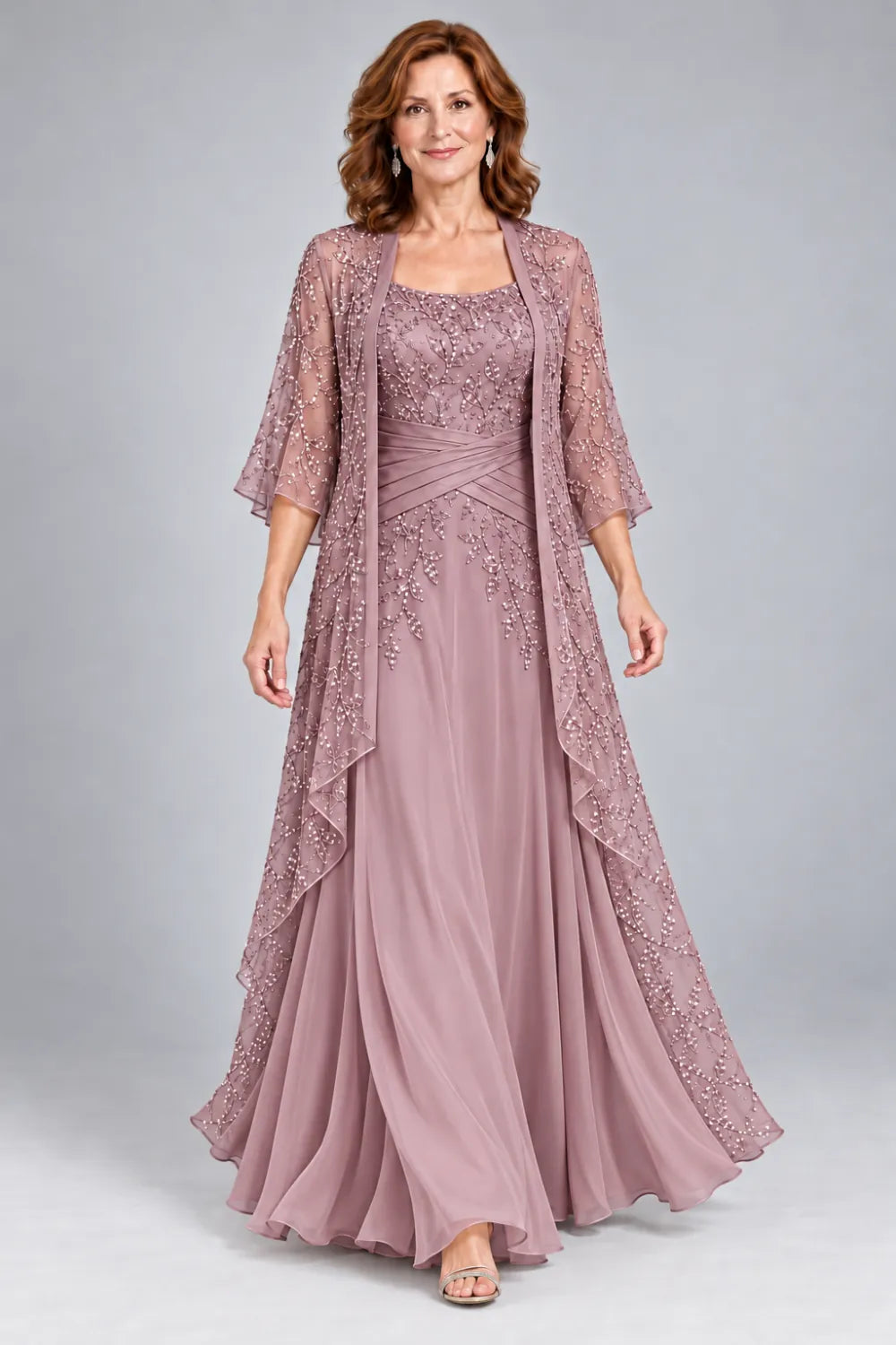 Mauve dress with lace bodice, diagonal waist gathers and cascading skirt panel, front view.