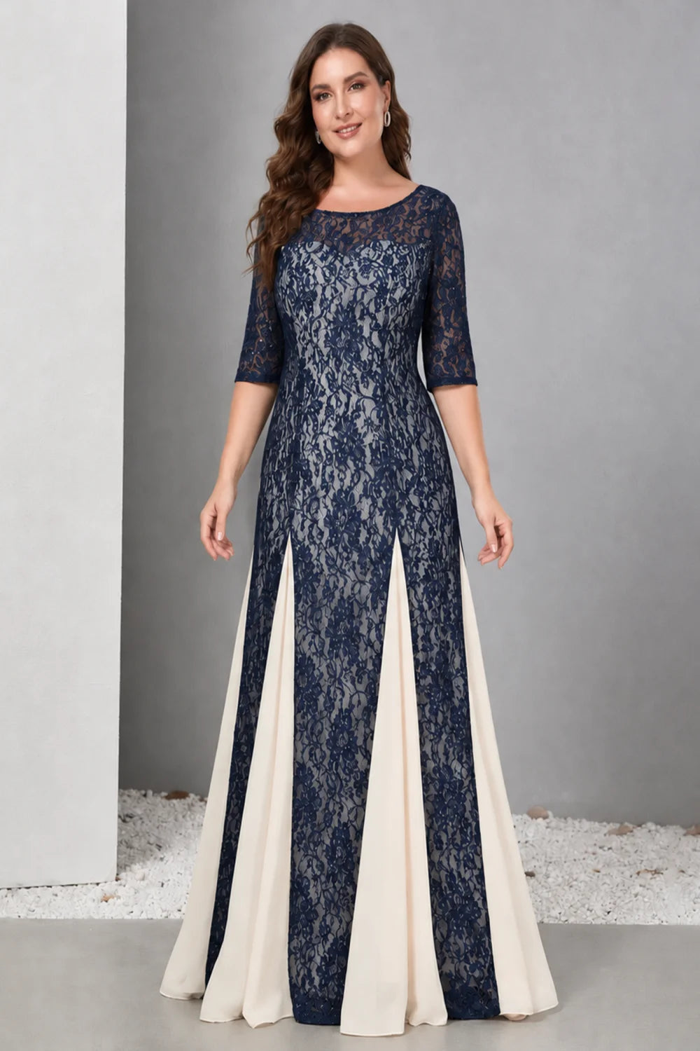 Front view of a navy blue dress with lace and contrasting pale skirt panels.