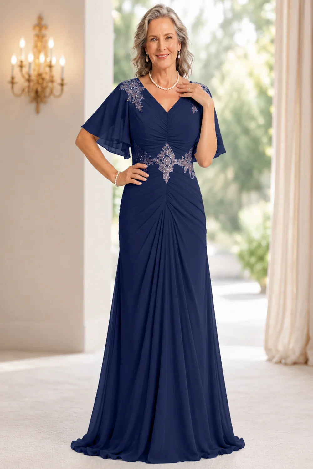 Front view of a navy blue dress with flutter sleeves and a ruched front.