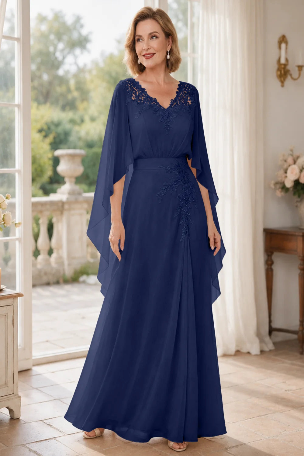 Front view of a navy blue dress with a lace V neckline and open cape panels.