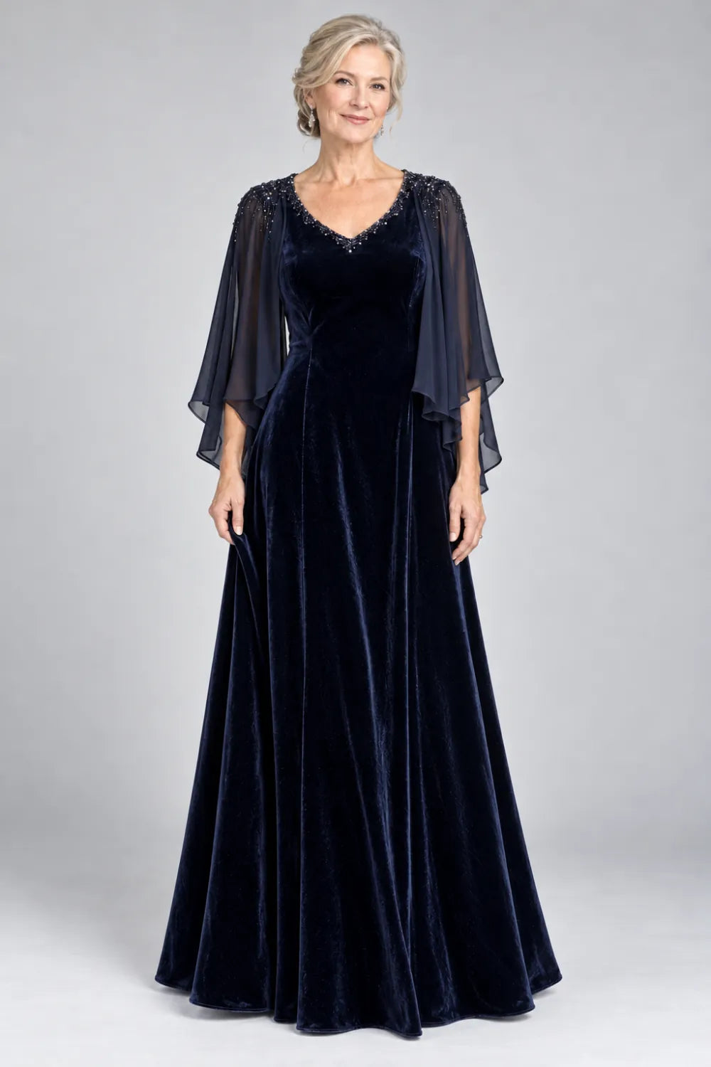 Navy Blue dress with beaded v-neck and layered cascading cape, front view.