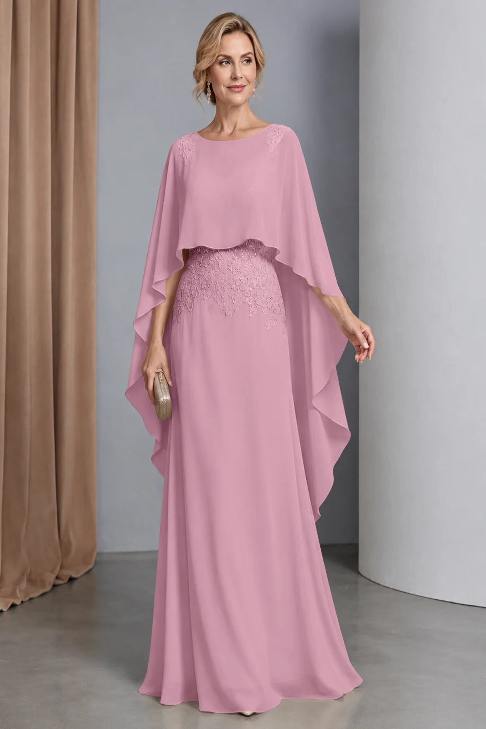 Front view of a pink dress with a curved cape front and embellished waist.