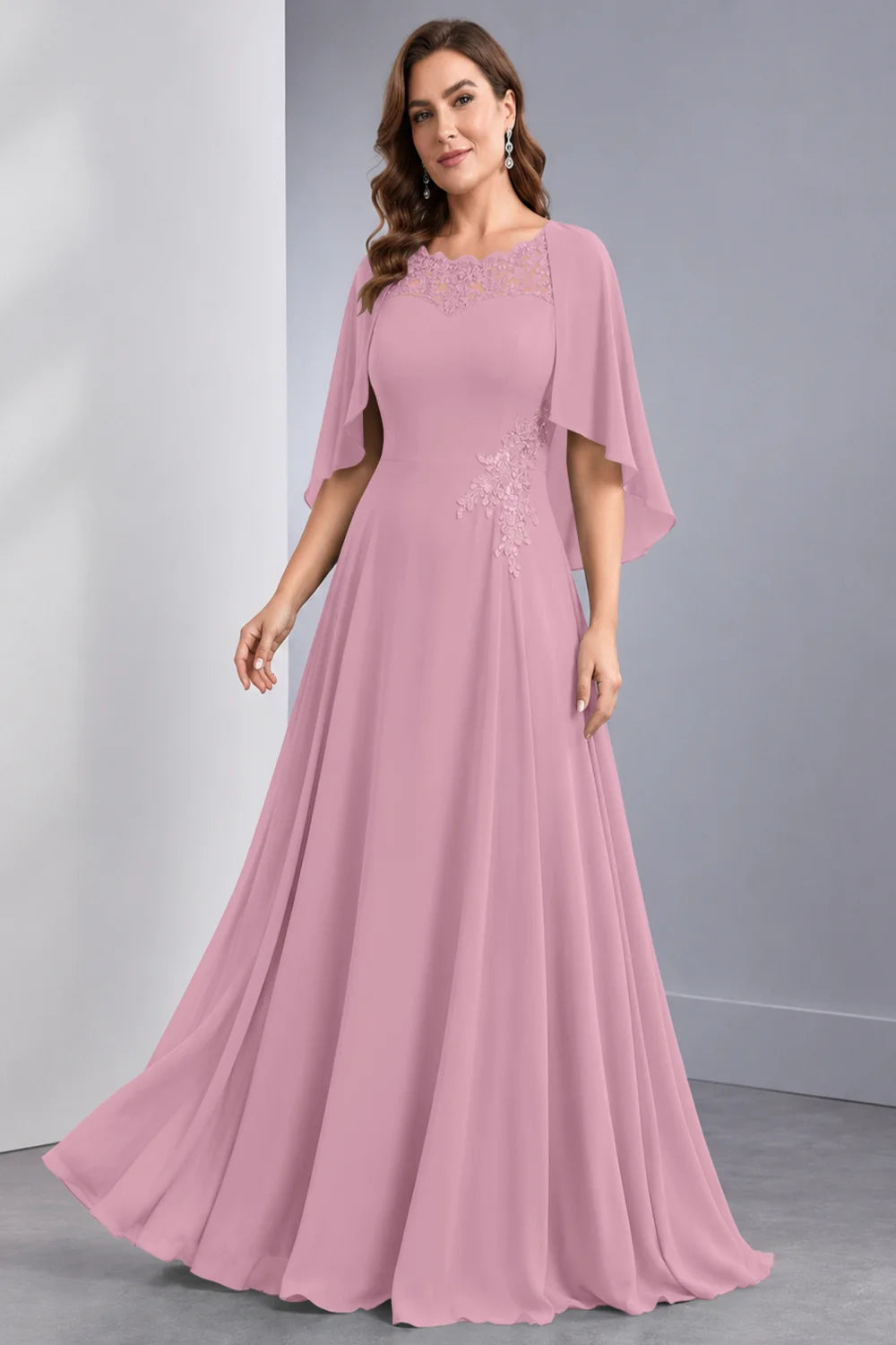 Front view of a pink dress with draped sleeve panels and a lace neckline.