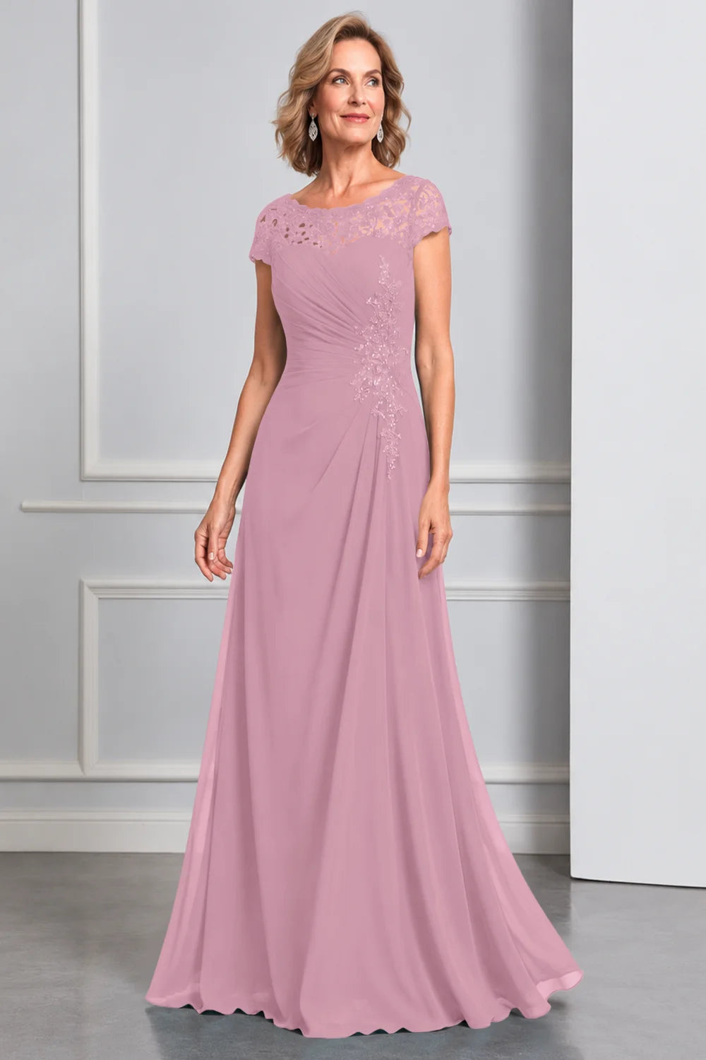Front view of a pink dress with lace cap sleeves and side waist decoration.
