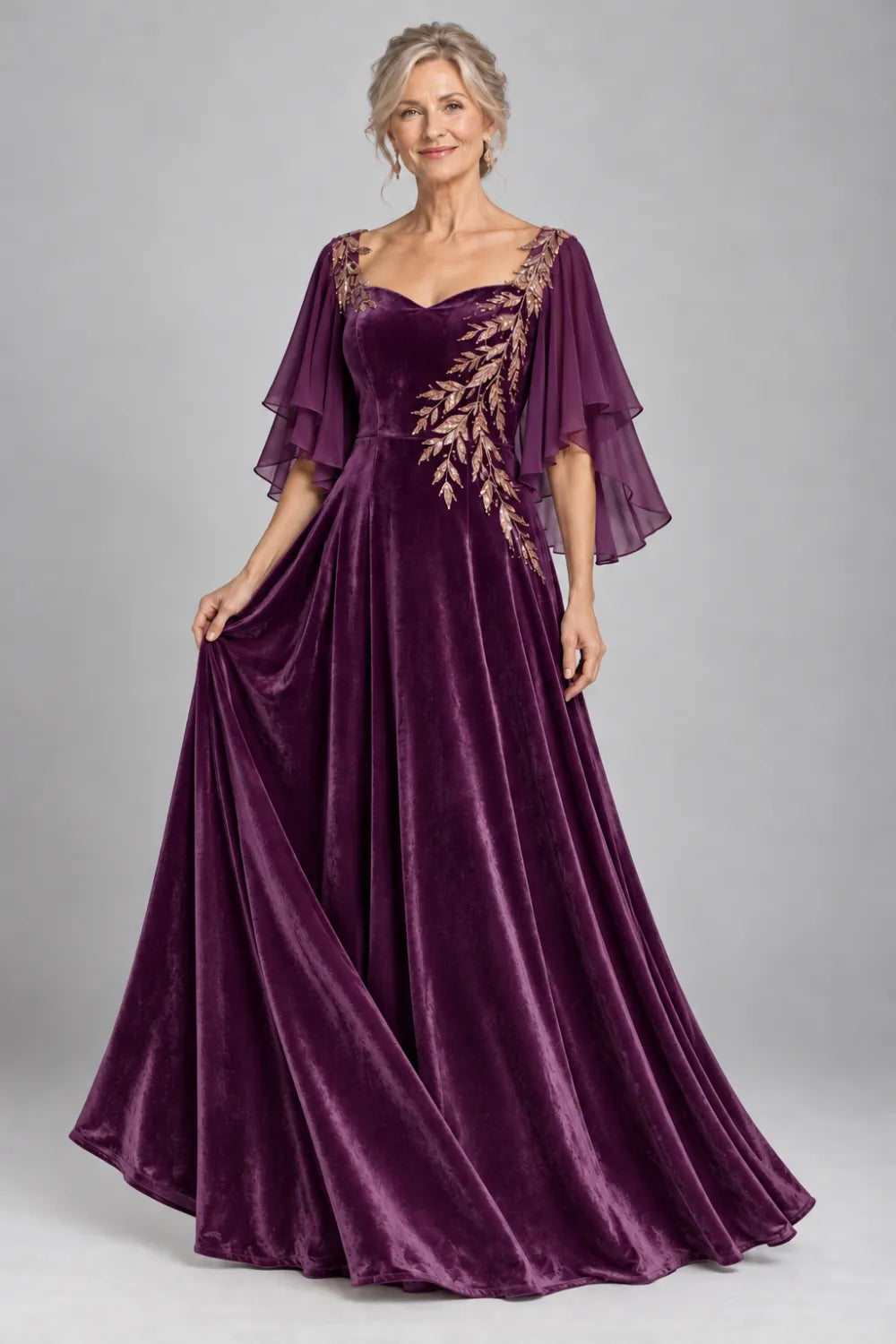 Plum dress with diagonal gold-tone leaf embroidery, front view.