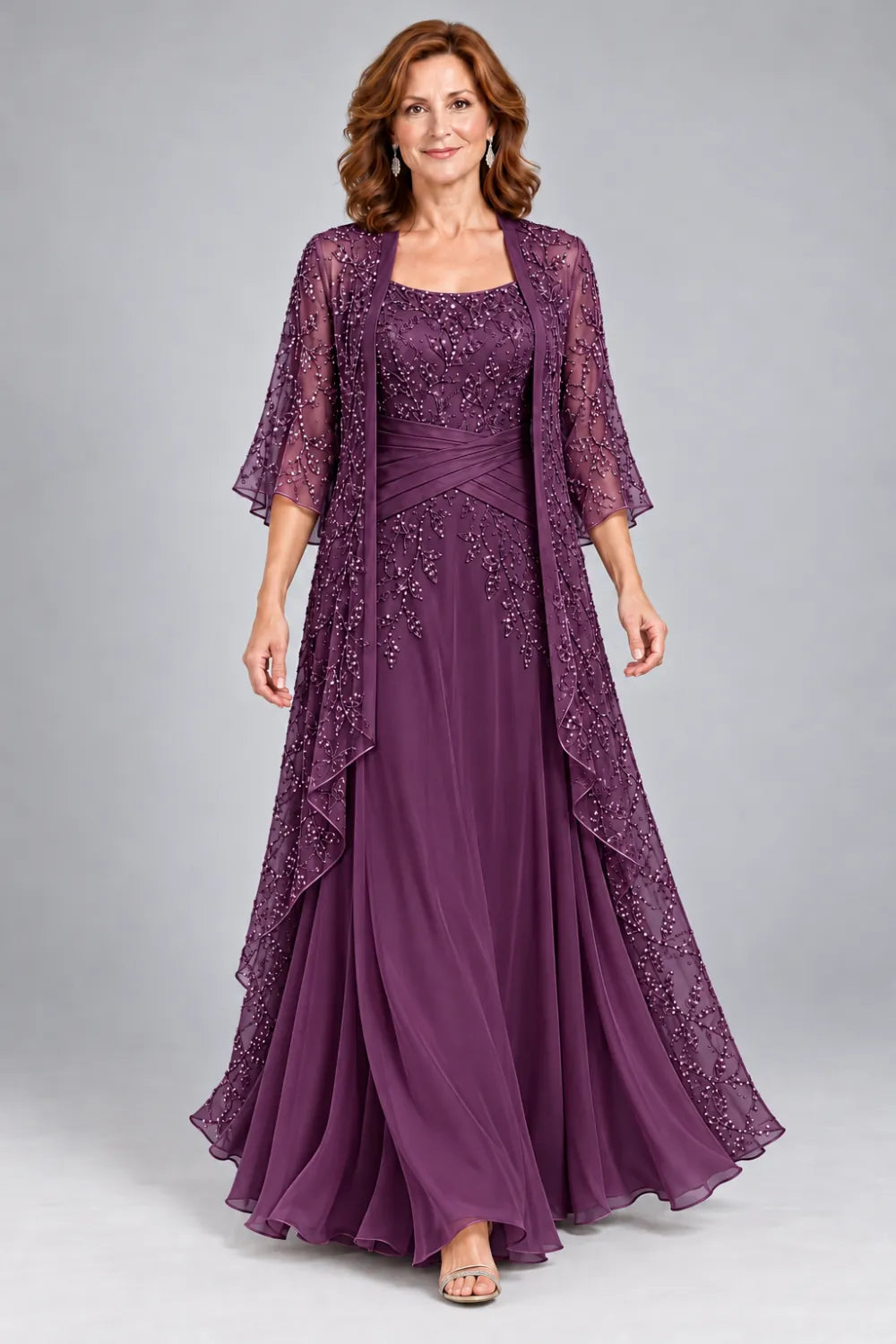 Plum dress with lace bodice, diagonal waist gathers and cascading skirt panel, front view.