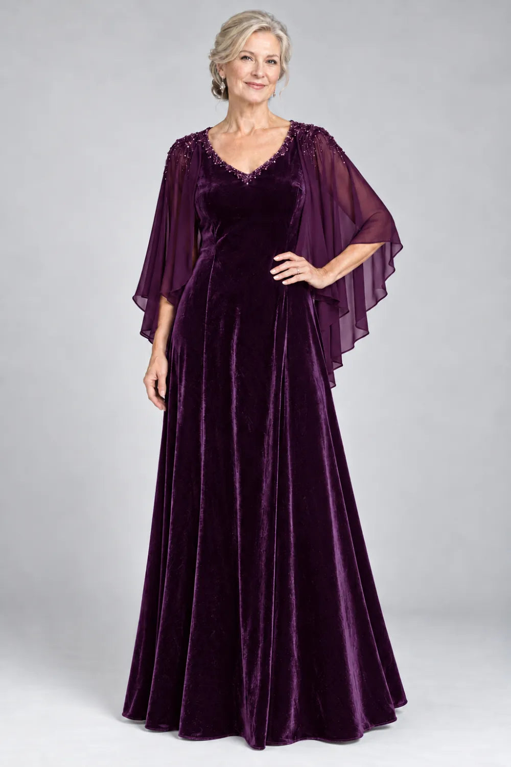 Plum dress with beaded v-neck and layered cascading cape, front view.