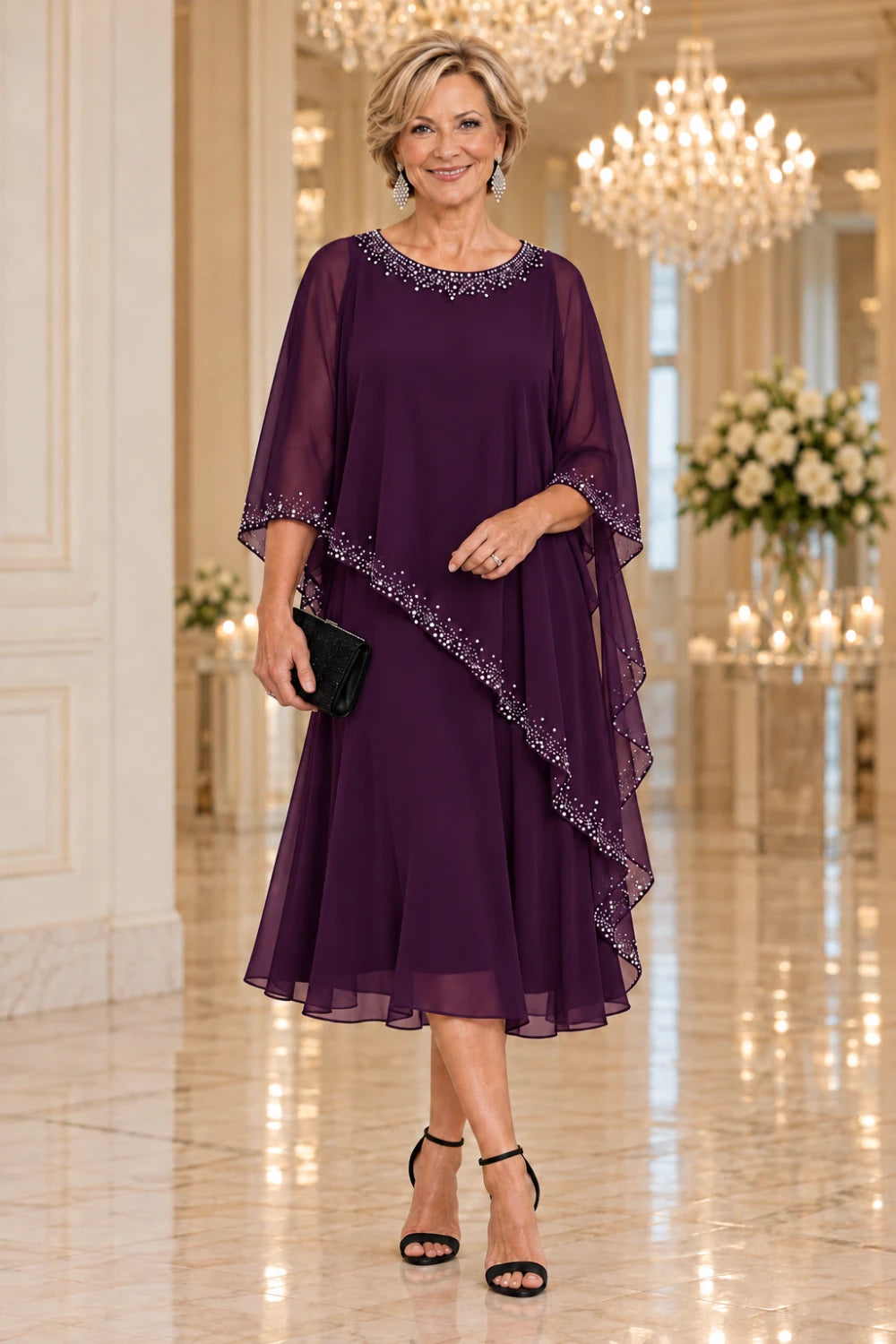 Plum dress with a sheer pointed cape and flared midi skirt, front view.