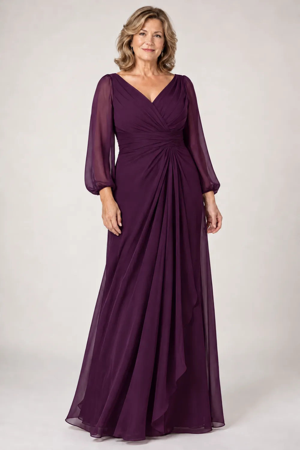Plum dress with crossover bodice, gathered waist and cascading side panel, front view.
