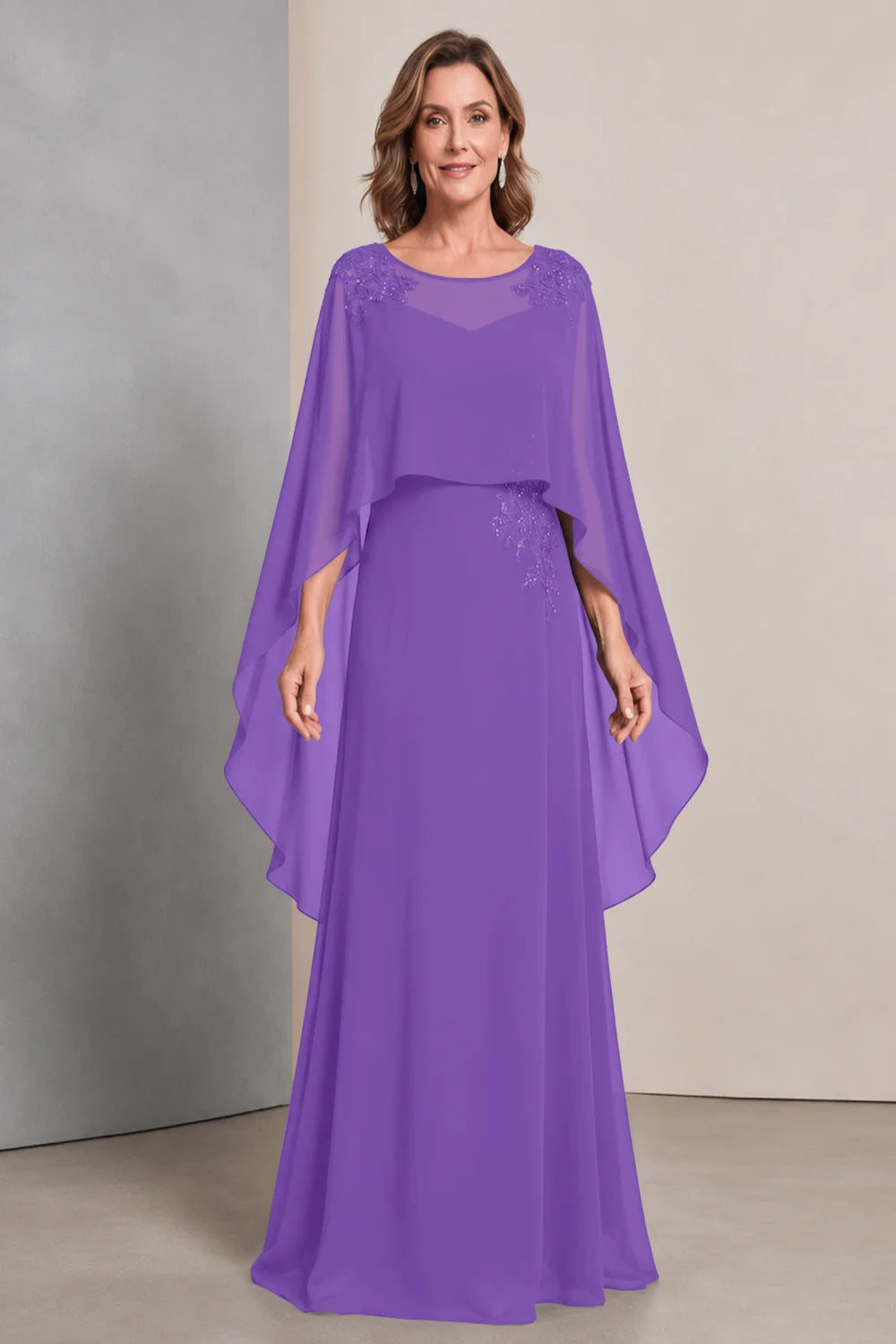 Front view of a purple dress with a sheer neckline and long cape sides.