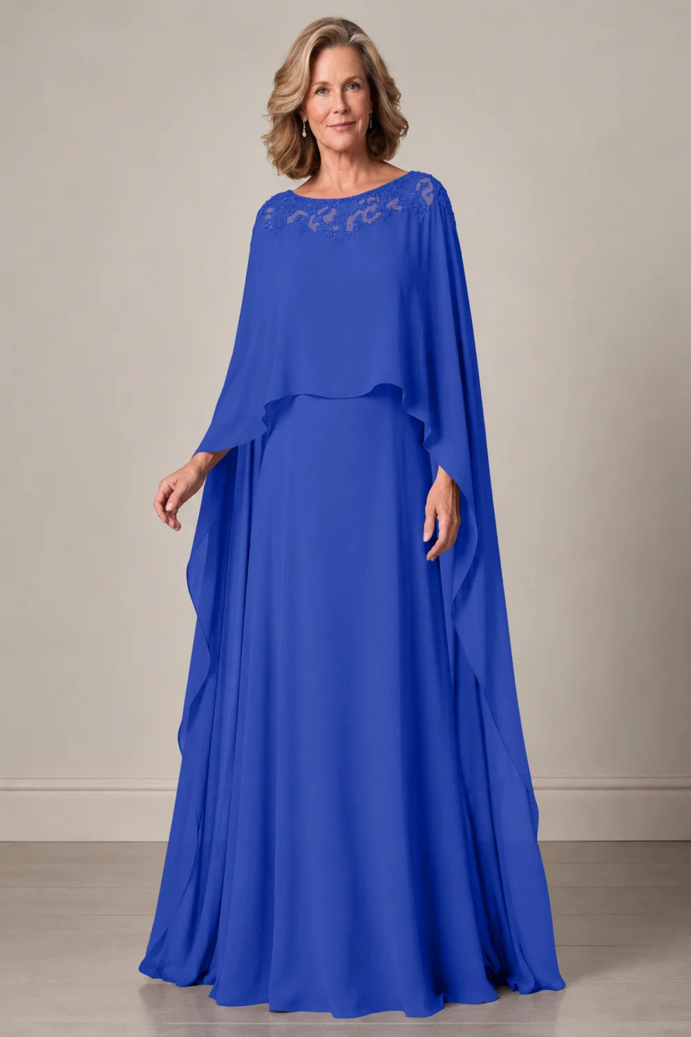 Front view of a royal blue dress with a decorated neckline and long cape panels.