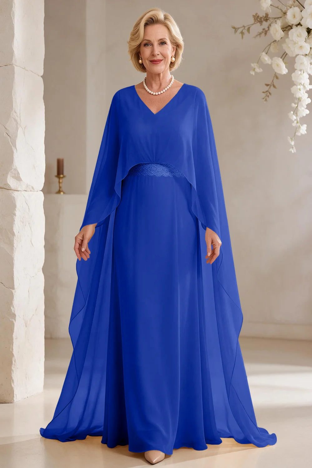 Front view of a royal blue dress with long cape panels and a flared skirt.