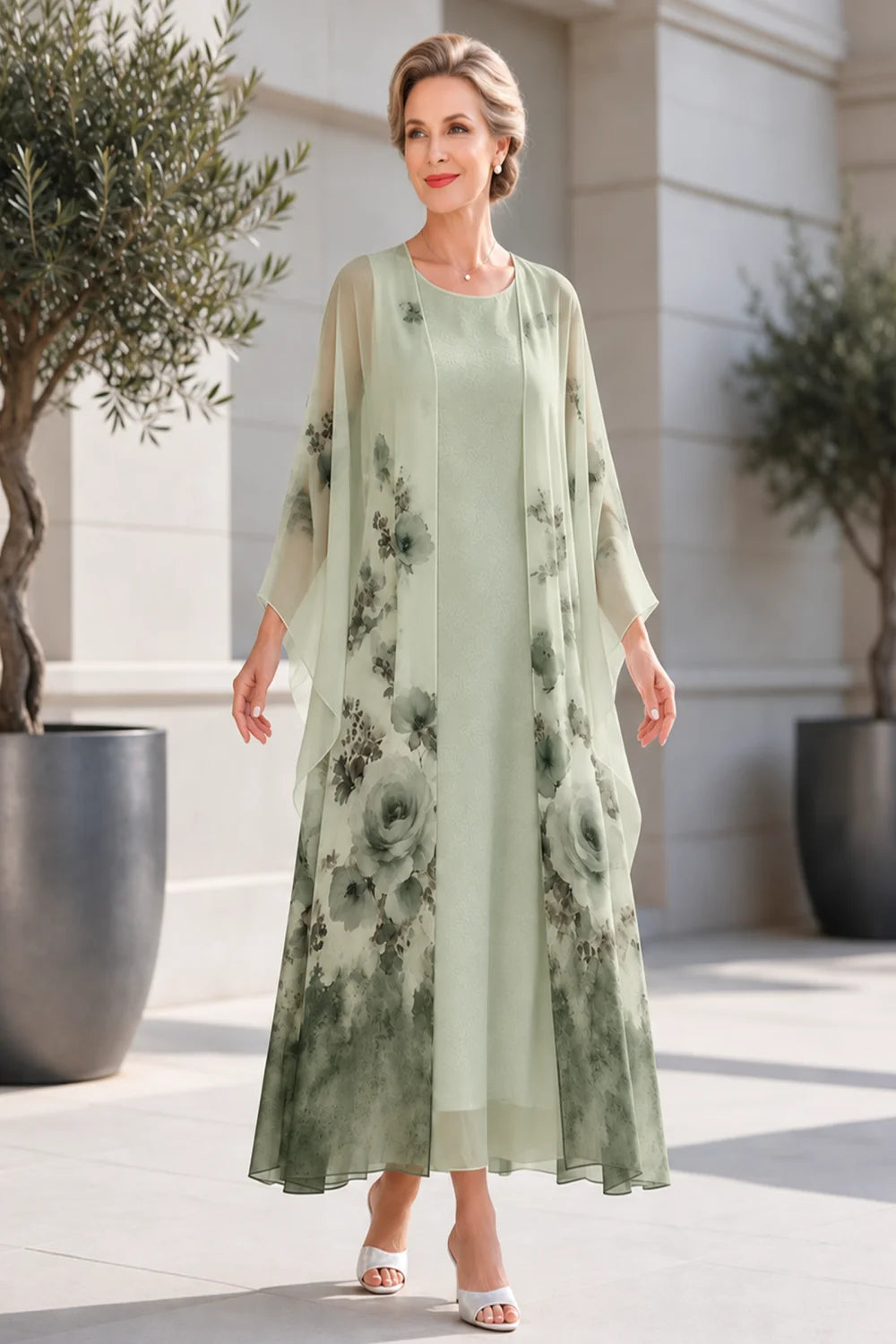 Front view of a sage green dress with a long floral outer layer.