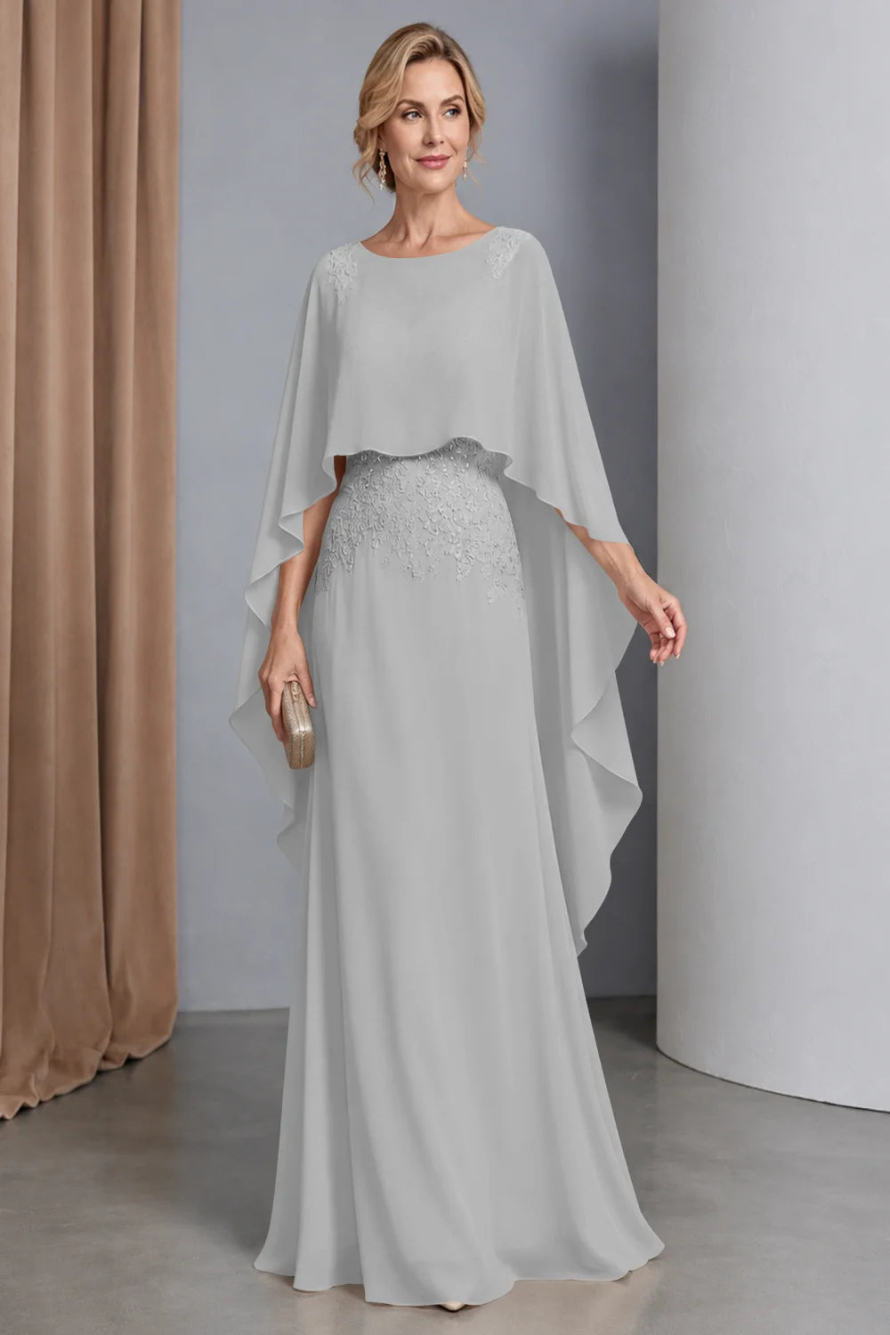 Front view of a silver gray dress with a curved cape front and embellished waist.