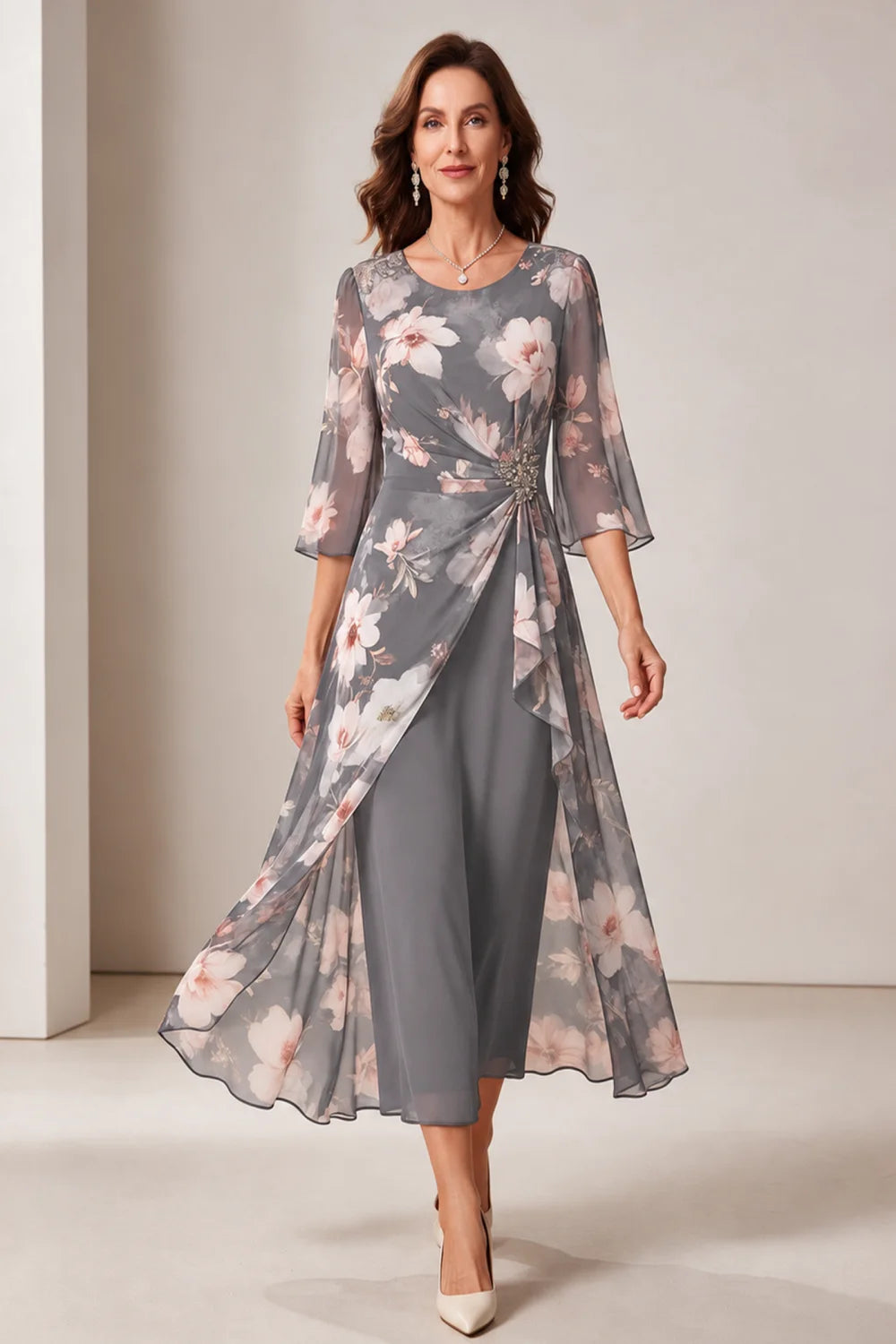 Front view of a silver gray dress with a floral overlay and flared sleeves.