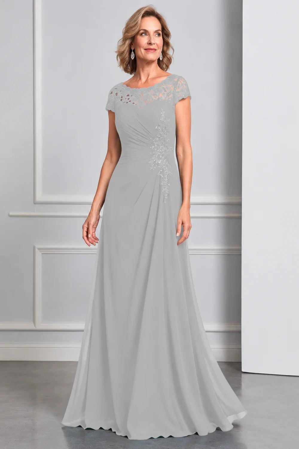 Front view of a silver gray dress with lace cap sleeves and side waist decoration.
