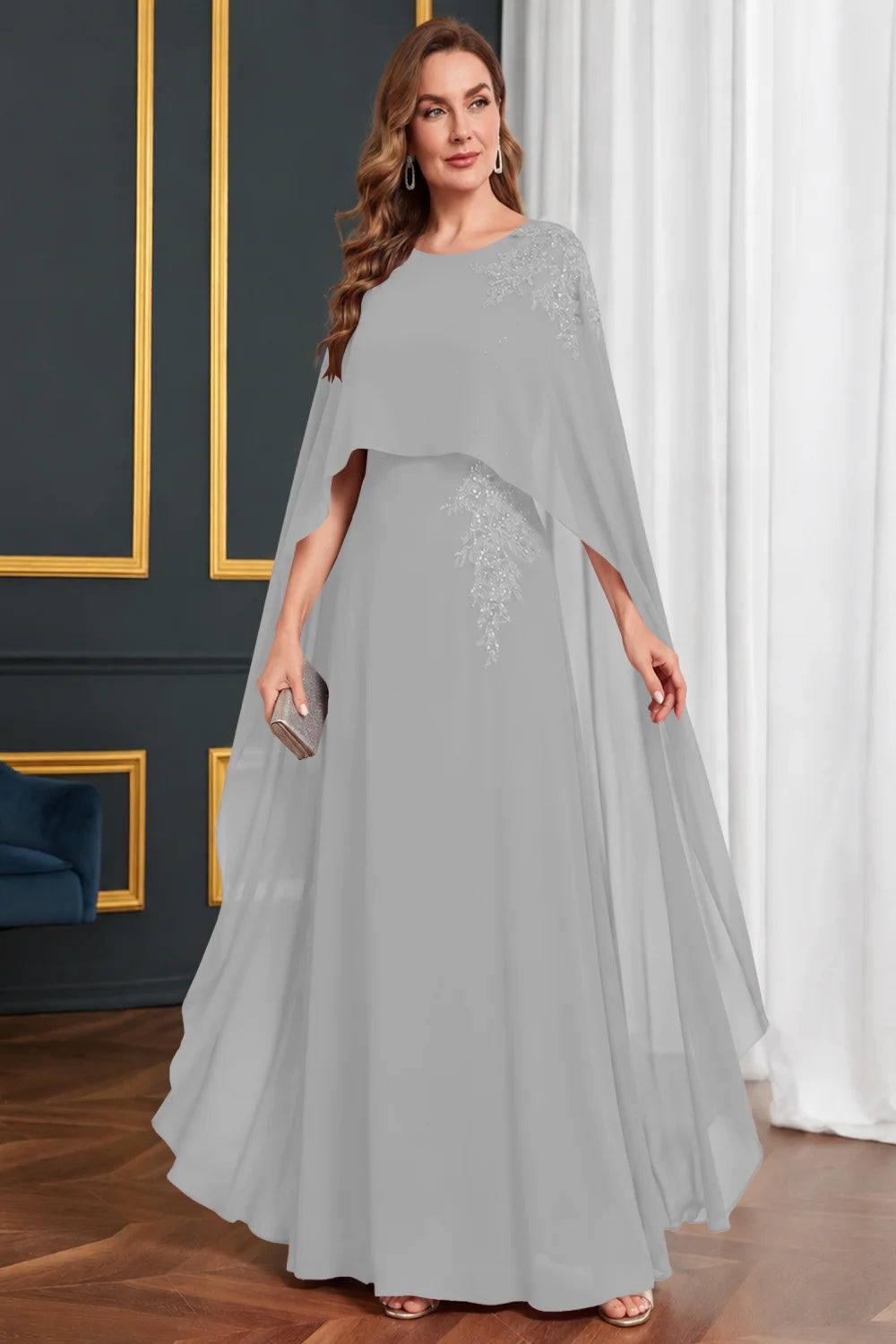 Front view of a silver gray dress with long cape panels and shoulder decoration.