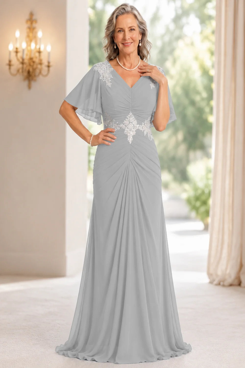 Front view of a silver gray dress with flutter sleeves and a ruched front.