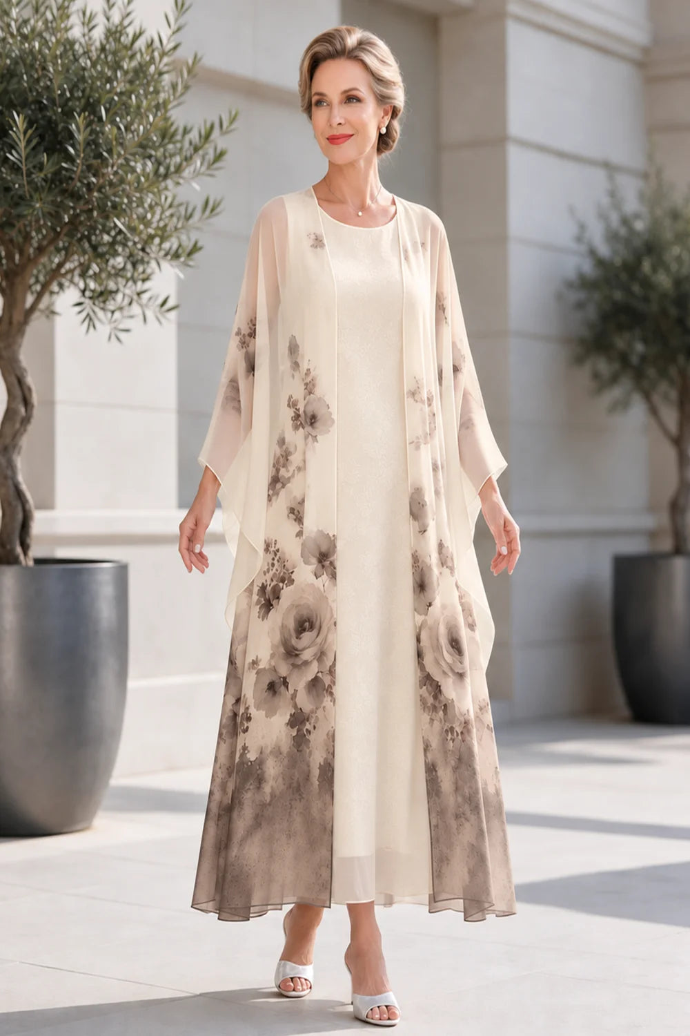 Front view of a taupe dress with a long floral outer layer.