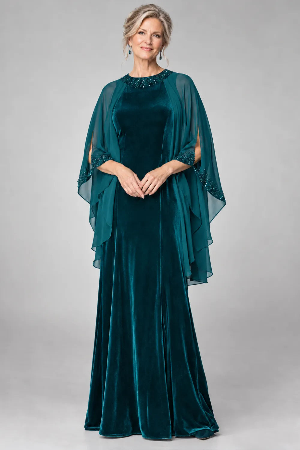Teal dress with beaded round neckline and cascading sheer cape, front view.