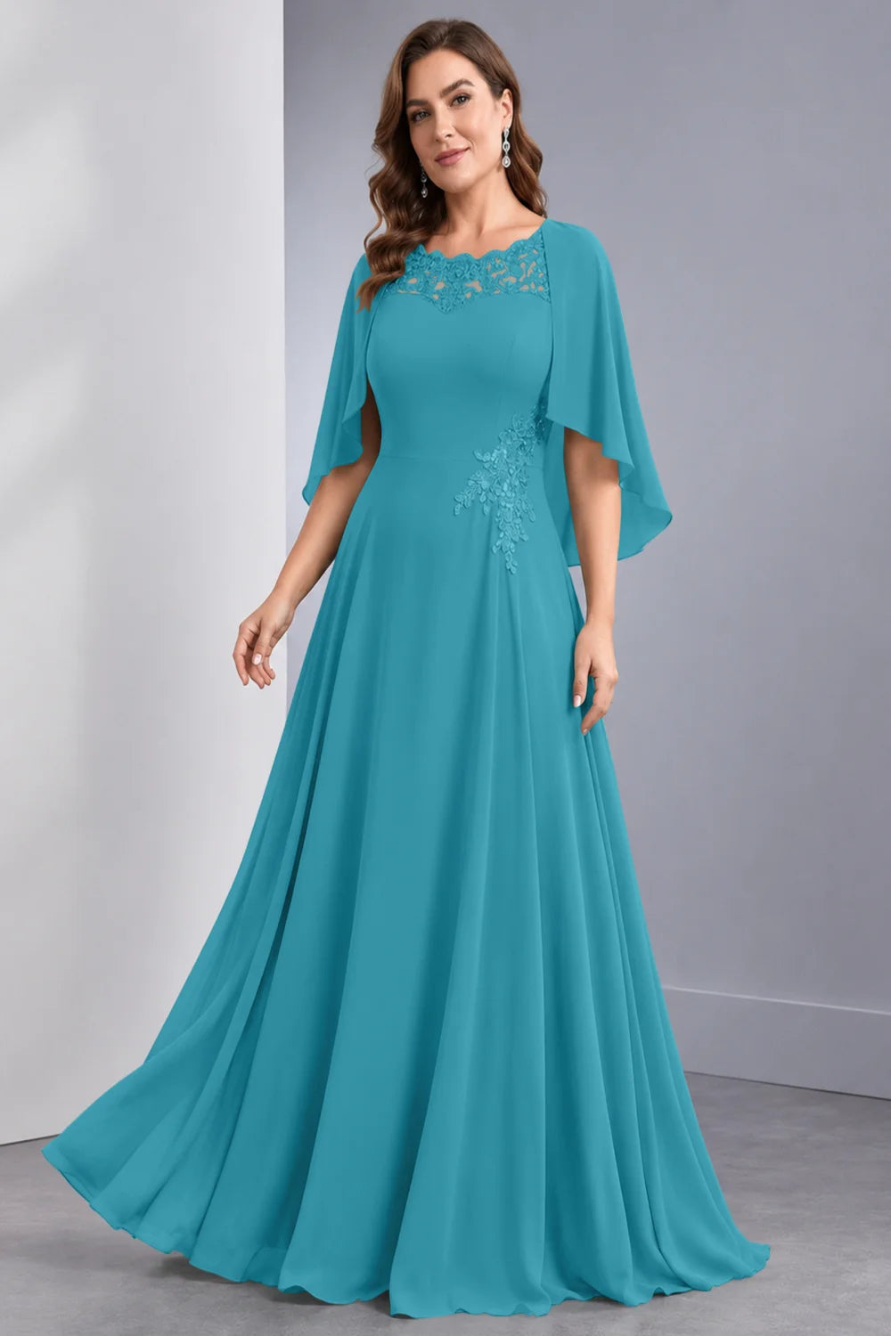 Front view of a teal dress with draped sleeve panels and a lace neckline.