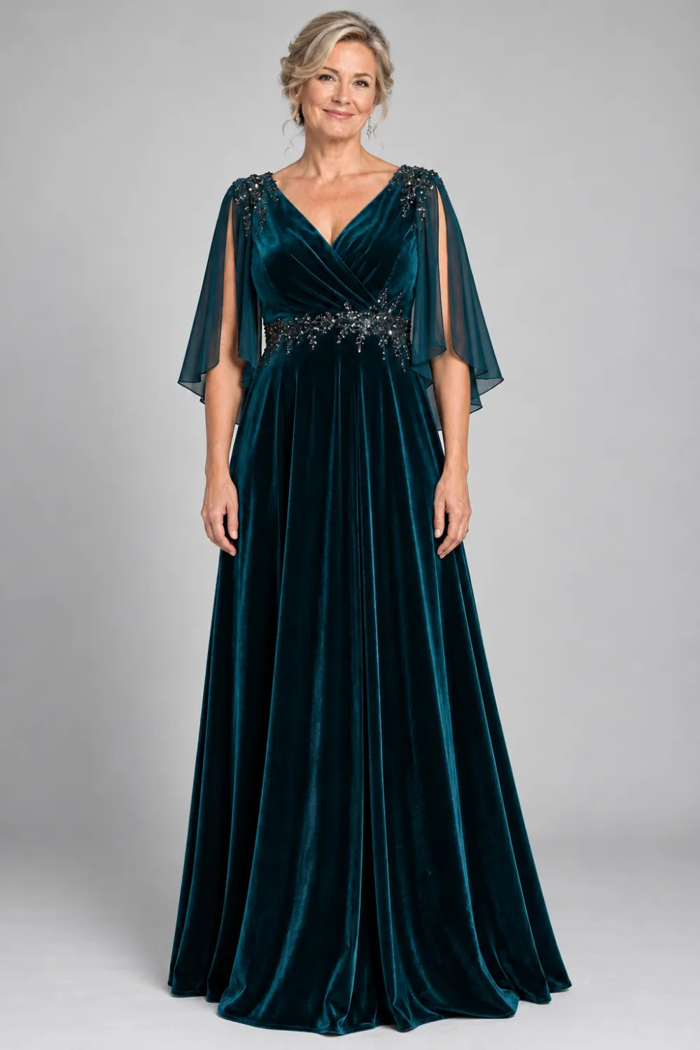 Teal dress with crossover bodice and decorated waist, front view.